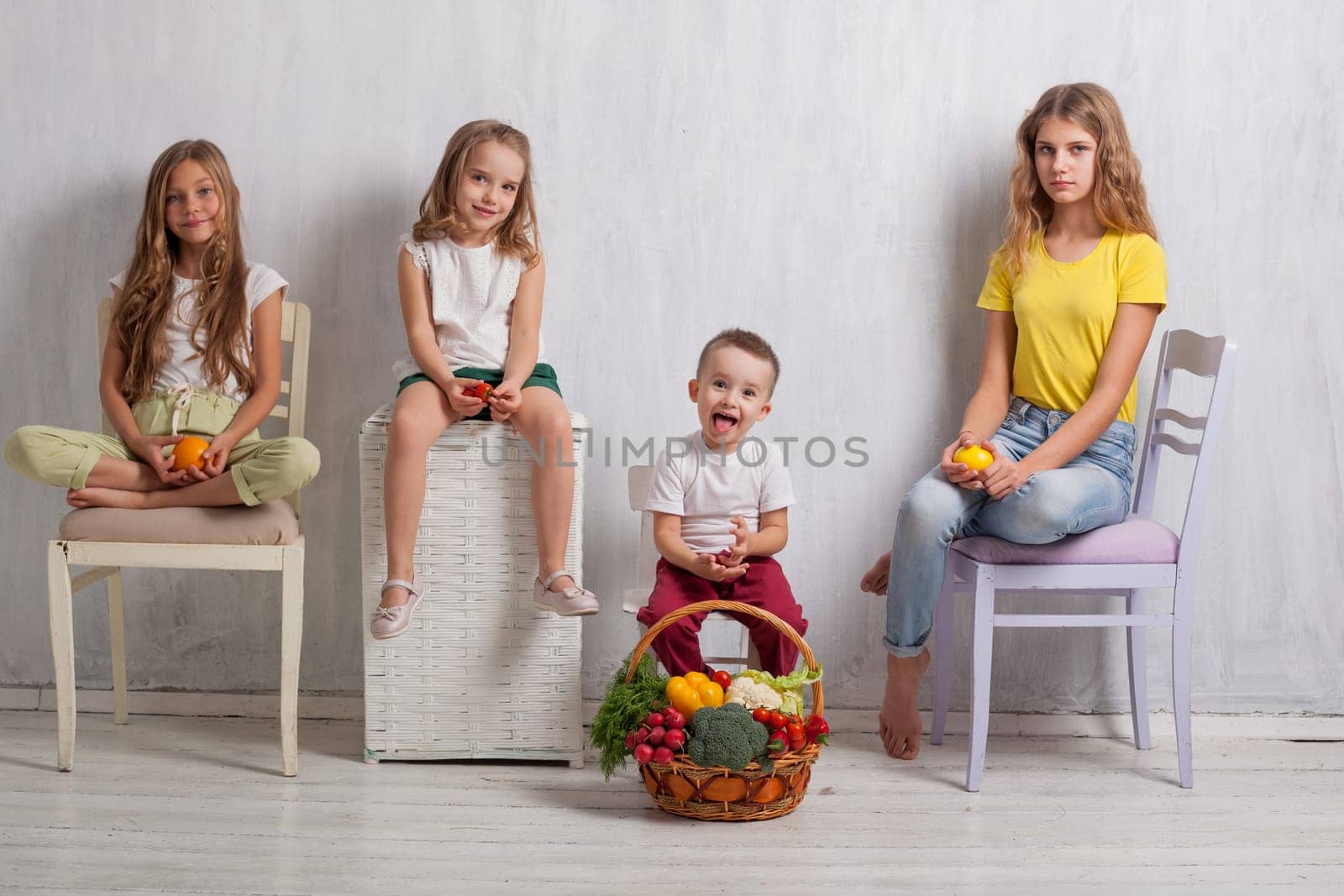kids boy and girls with a basket of ripe vegetables and fruits by Simakov