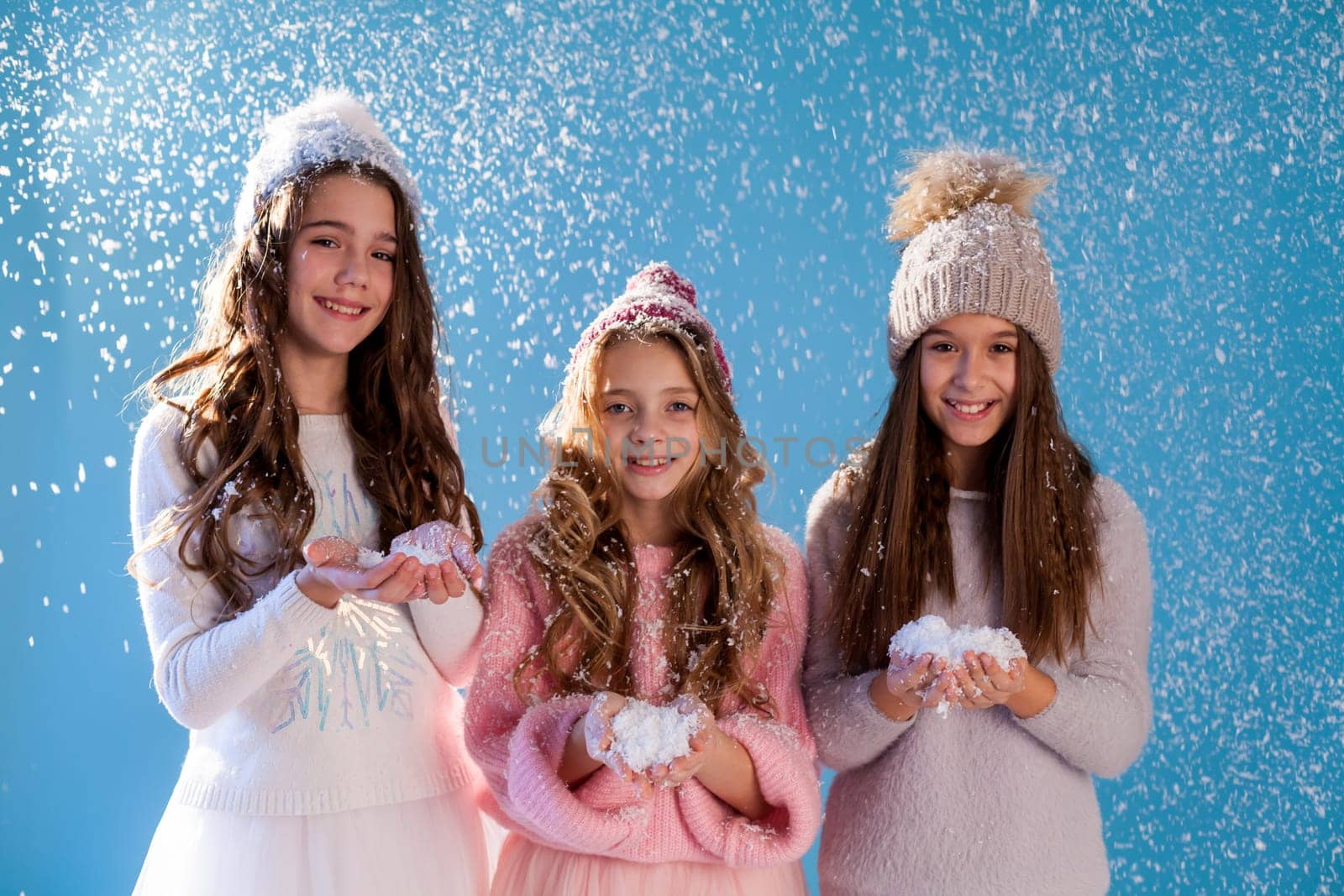 Three girl girlfriends play with snow in winter by Simakov