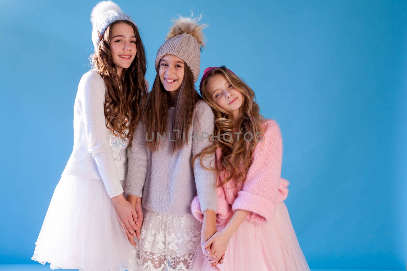 portrait of three beautiful girls in a winter hat by Simakov