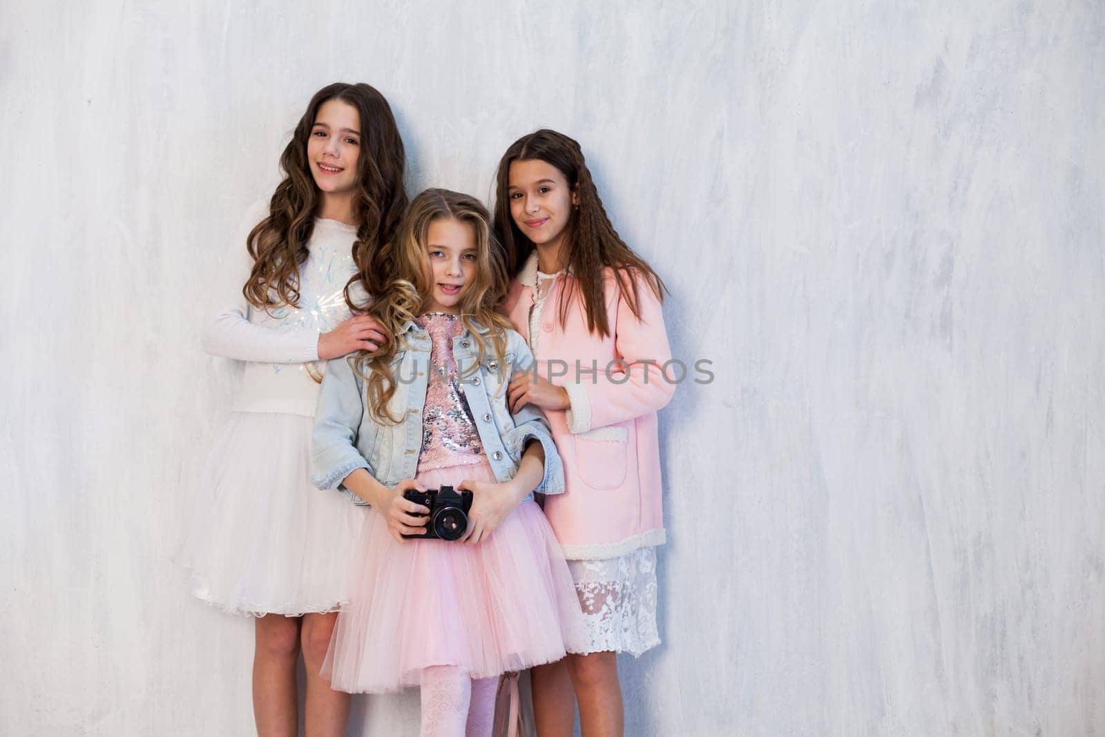 Three beautiful girls with a camera at a photo shoot by Simakov