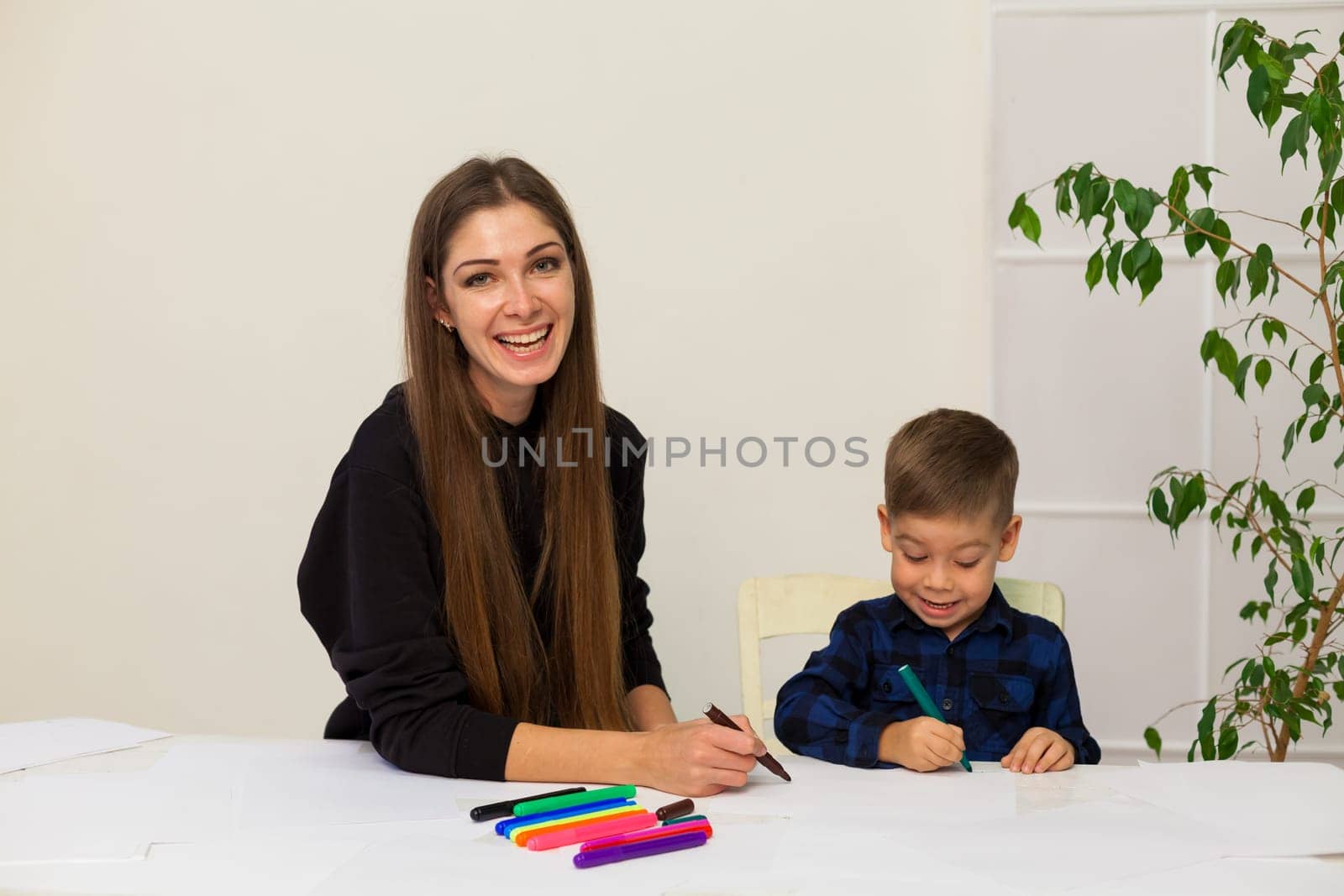 Mom with a little boy learn to draw markers by Simakov
