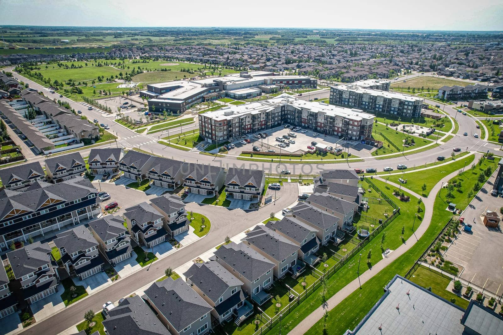 Captivating aerial shot of Stonebridge in Saskatoon, highlighting the harmonious blend of modern architecture and Saskatchewan's verdant surroundings.