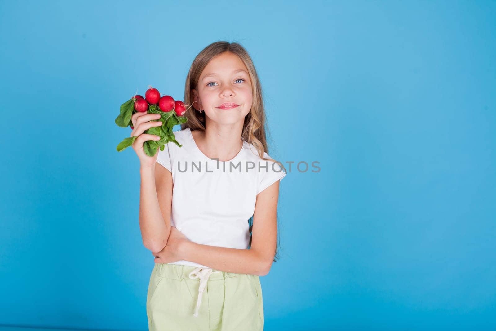 Beautiful girl holding ripe vegetables radish