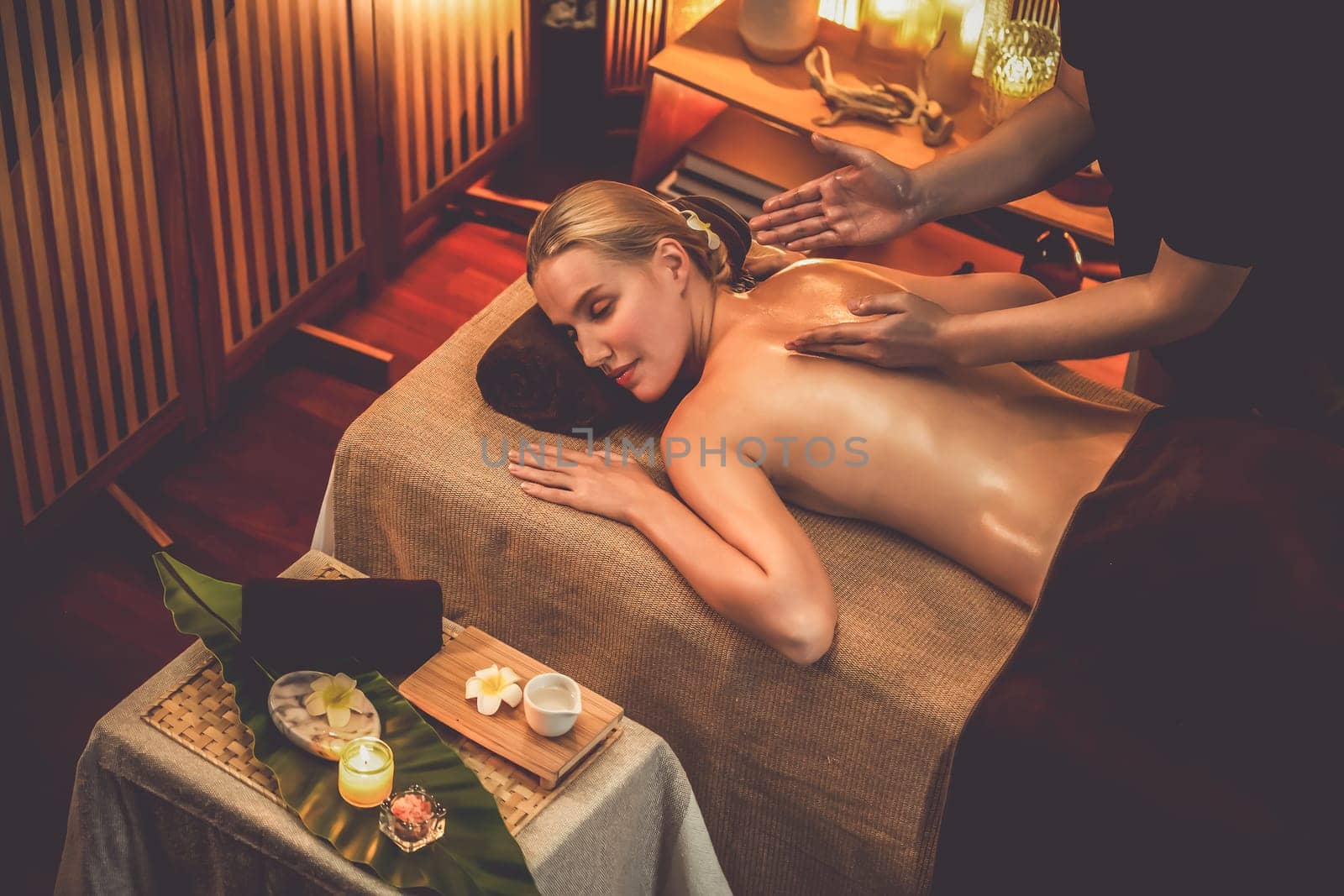 Caucasian woman customer enjoying relaxing anti-stress massage. Quiescent by biancoblue