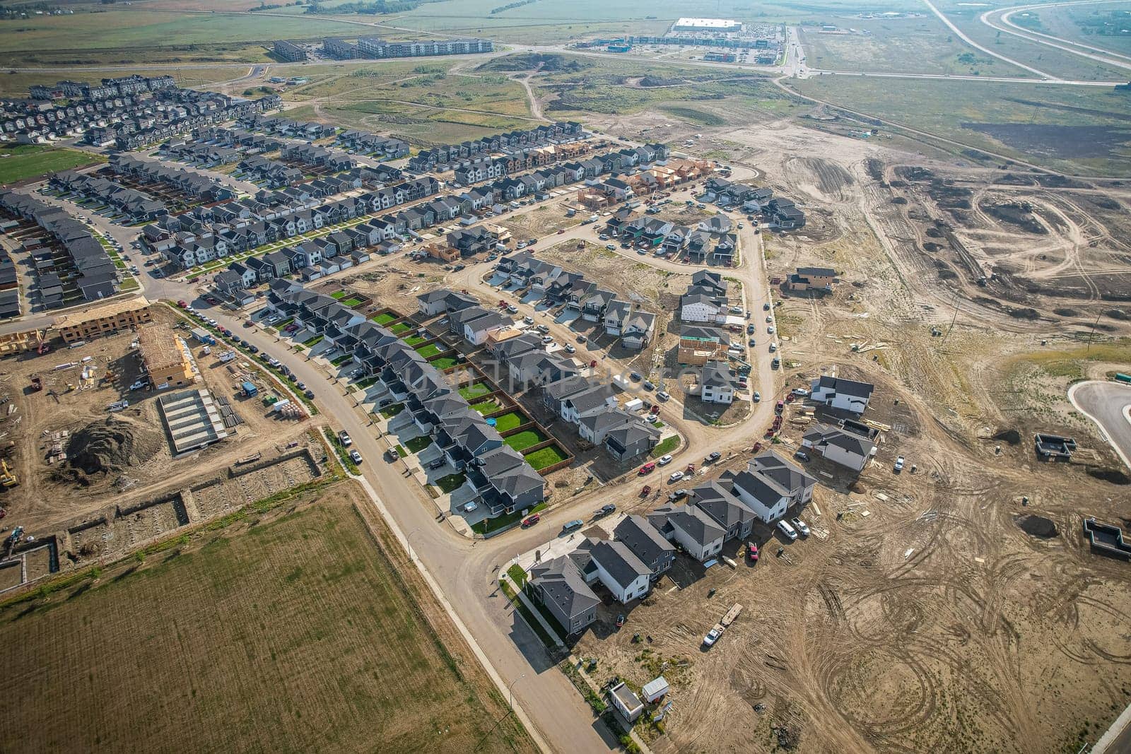 Elevated view of Rosewood neighborhood in Saskatoon, presenting a tapestry of urban design intertwined with Saskatchewan's serene natural canvas.
