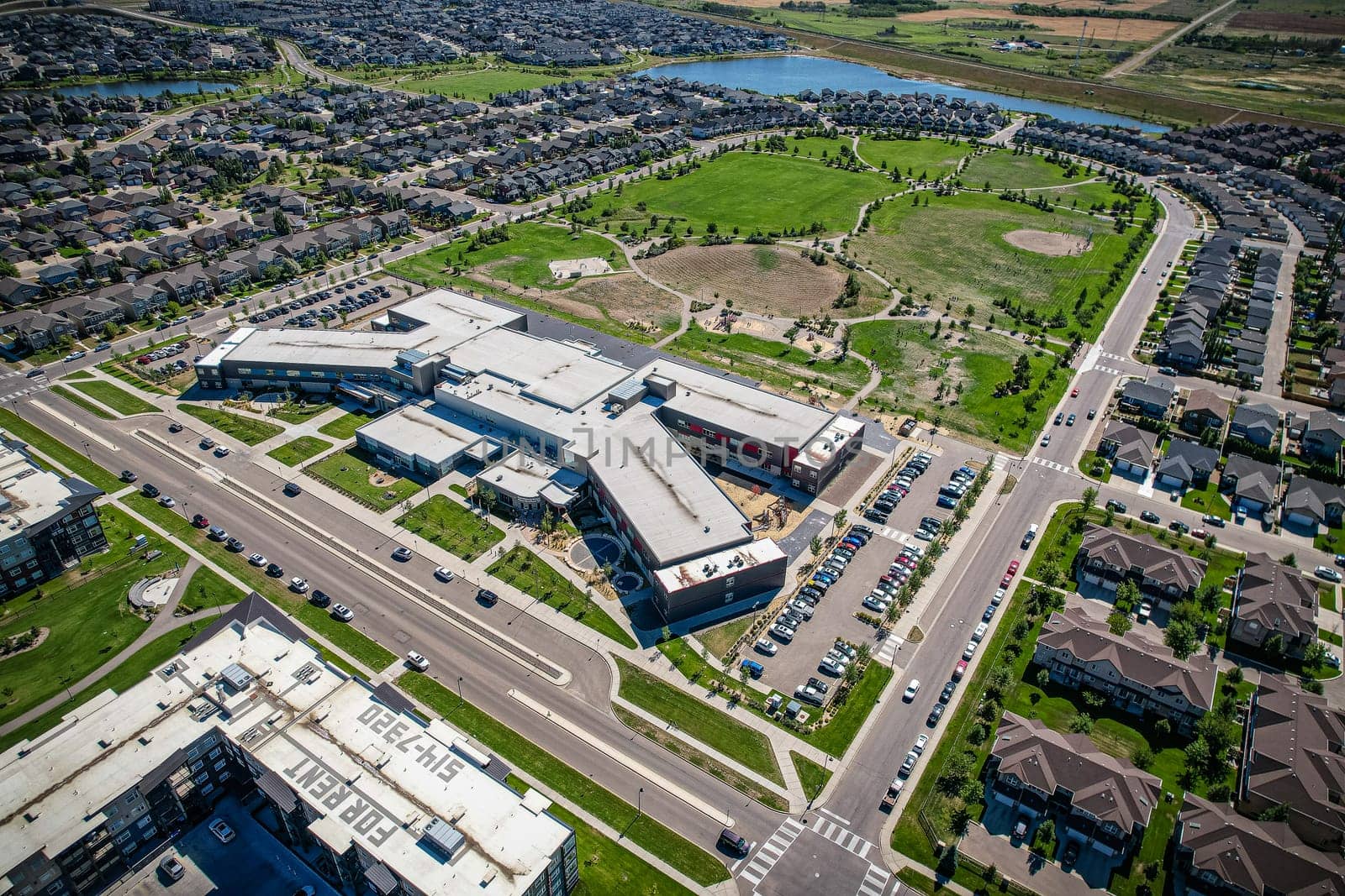 Captivating aerial shot of Stonebridge in Saskatoon, highlighting the harmonious blend of modern architecture and Saskatchewan's verdant surroundings.