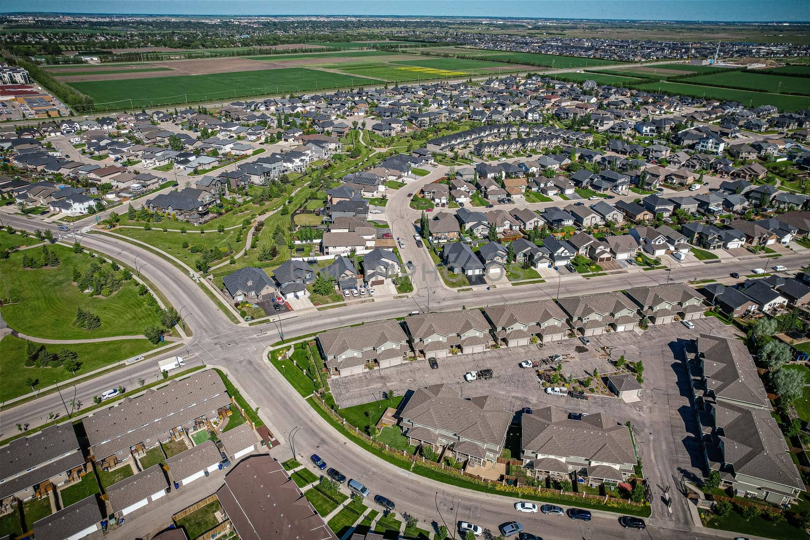 Elevated panorama of Willowgrove, showcasing the neighborhood's modern aesthetics intertwined with pockets of lush green, epitomizing Saskatoon's suburban beauty