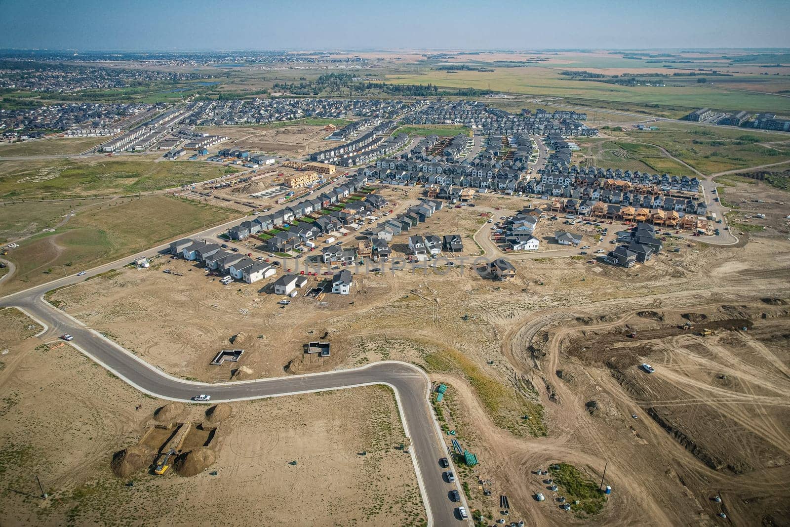 Elevated view of Rosewood neighborhood in Saskatoon, presenting a tapestry of urban design intertwined with Saskatchewan's serene natural canvas.