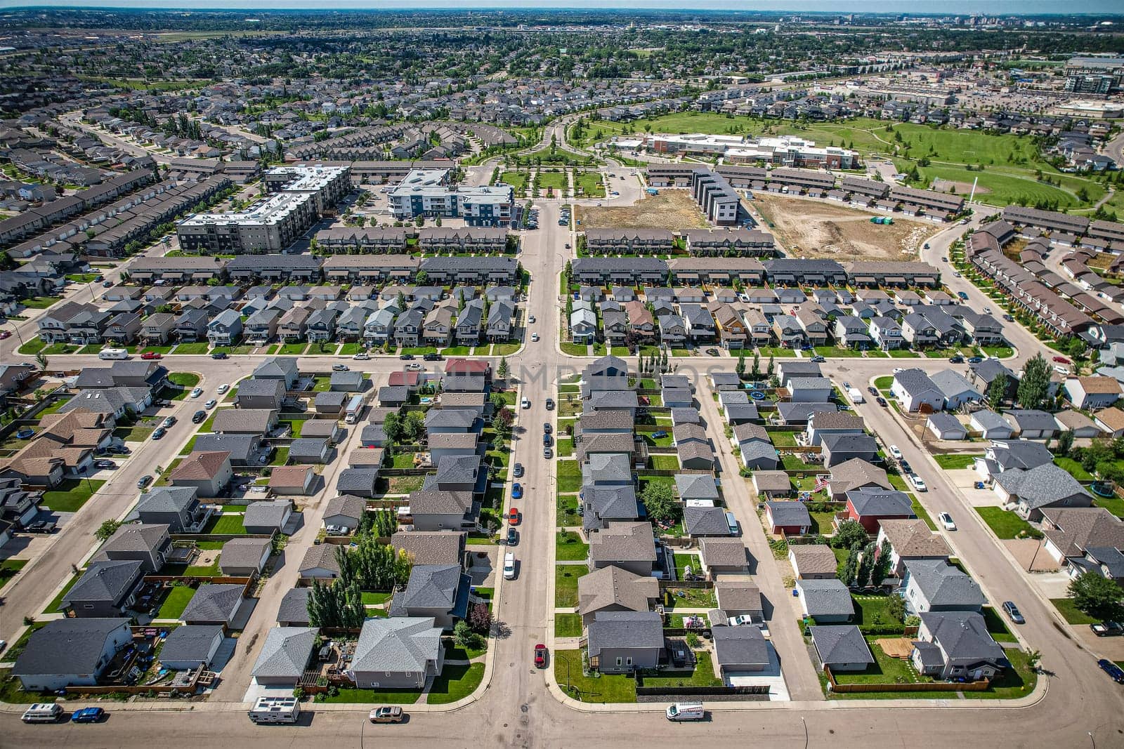 Elevated panorama of Willowgrove, showcasing the neighborhood's modern aesthetics intertwined with pockets of lush green, epitomizing Saskatoon's suburban beauty