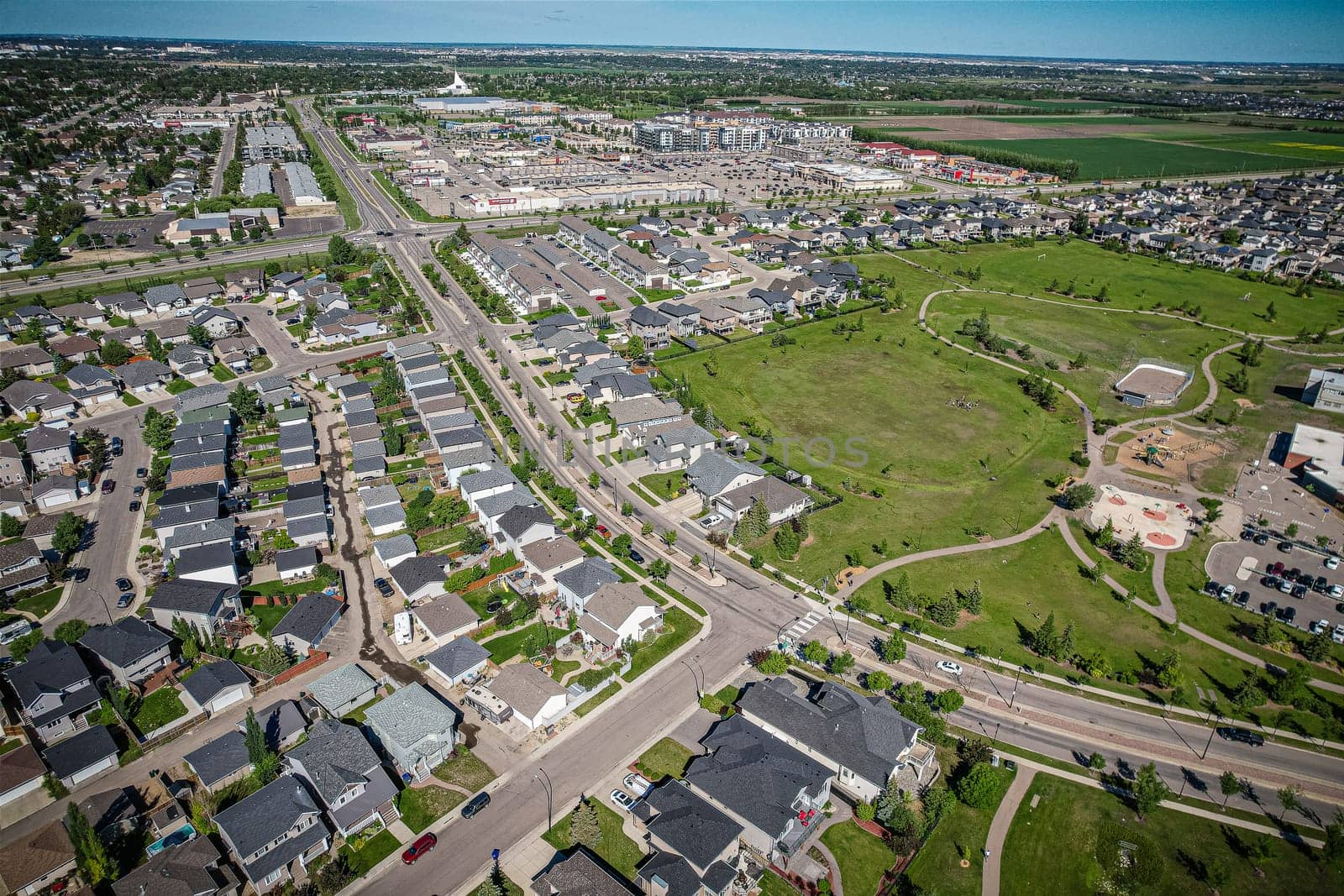 Elevated panorama of Willowgrove, showcasing the neighborhood's modern aesthetics intertwined with pockets of lush green, epitomizing Saskatoon's suburban beauty