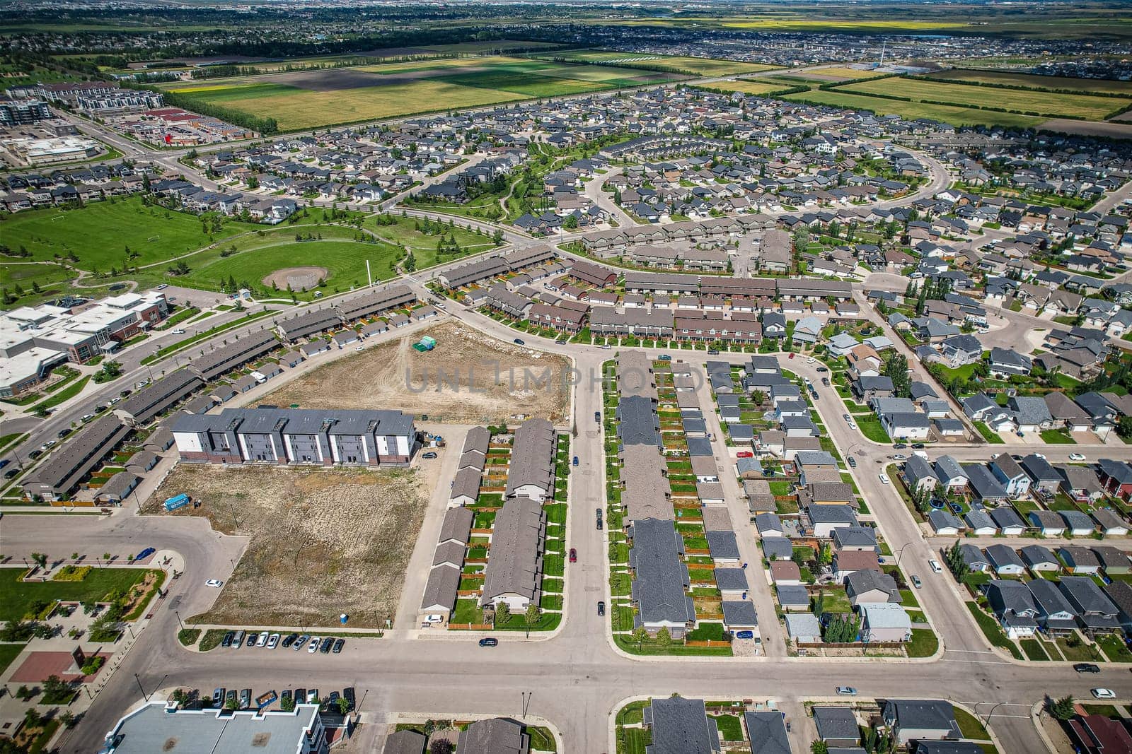 Elevated panorama of Willowgrove, showcasing the neighborhood's modern aesthetics intertwined with pockets of lush green, epitomizing Saskatoon's suburban beauty