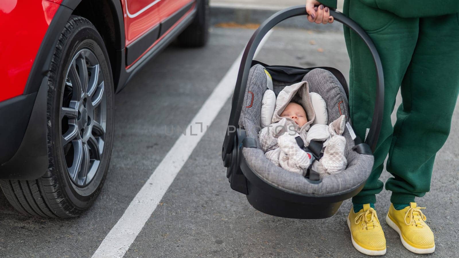 Woman holding baby chair with newborn baby. by mrwed54