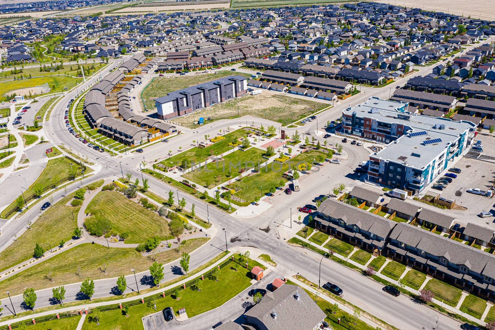 Aerial image of Willowgrove, Saskatoon, SK, showcasing its modern homes, intricate pathways, and lush parks. A neighborhood echoing family-centric living. Ideal for urban planning and real estate.