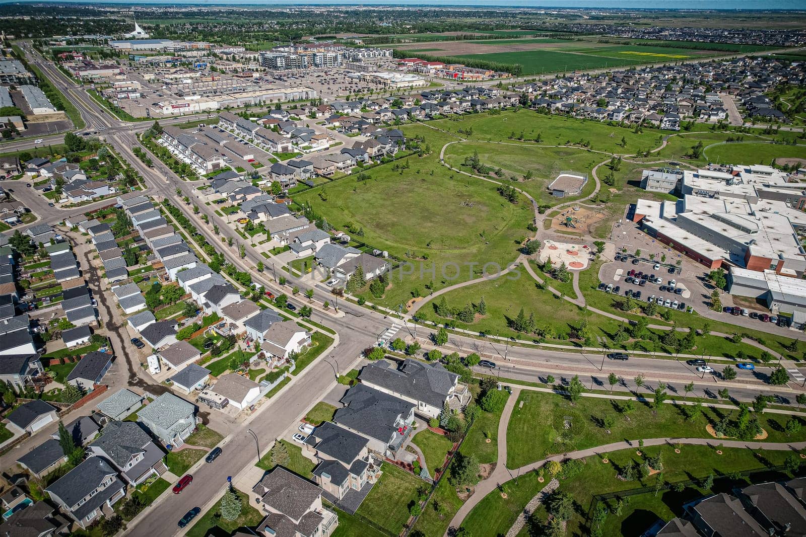 Elevated panorama of Willowgrove, showcasing the neighborhood's modern aesthetics intertwined with pockets of lush green, epitomizing Saskatoon's suburban beauty