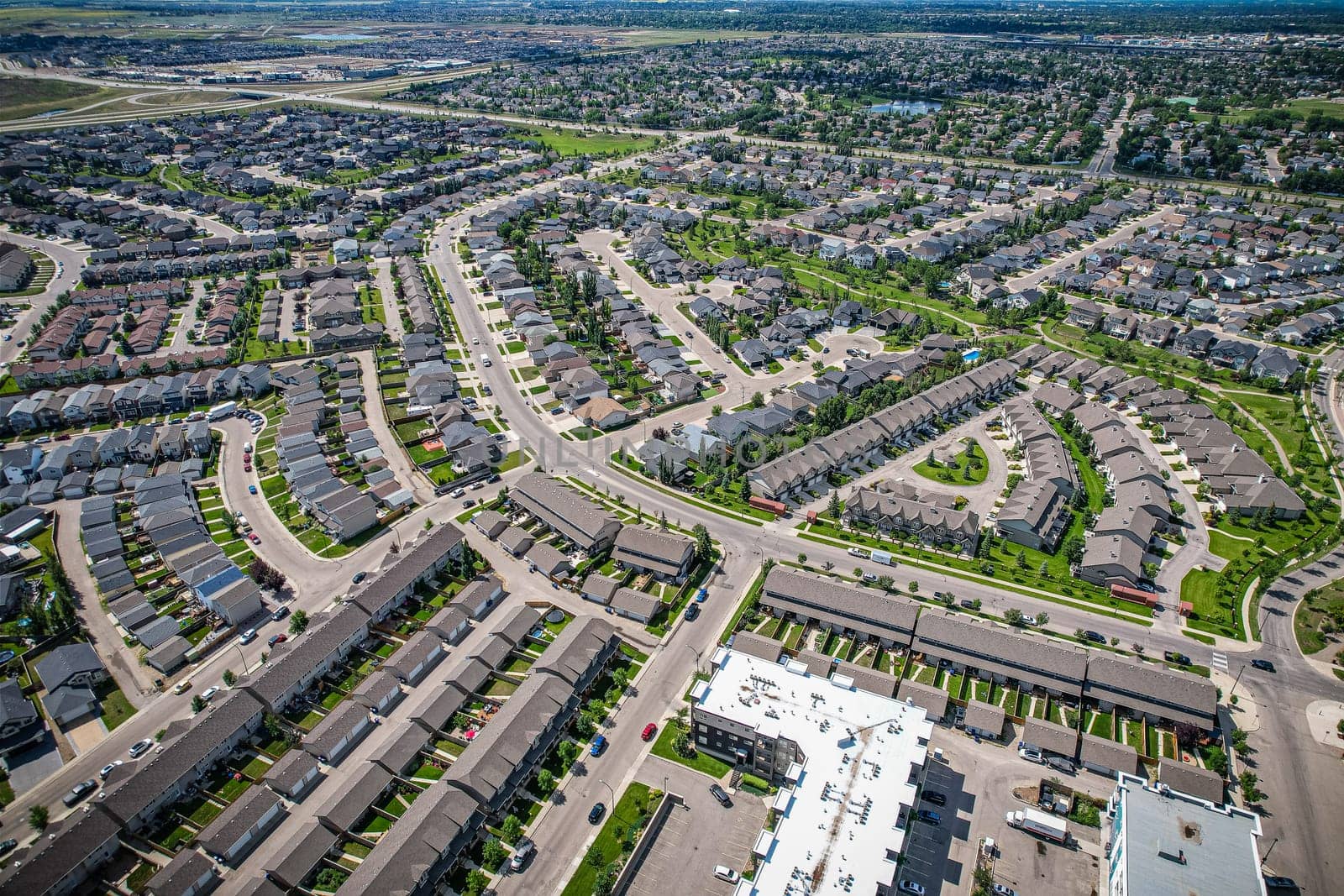 Elevated panorama of Willowgrove, showcasing the neighborhood's modern aesthetics intertwined with pockets of lush green, epitomizing Saskatoon's suburban beauty
