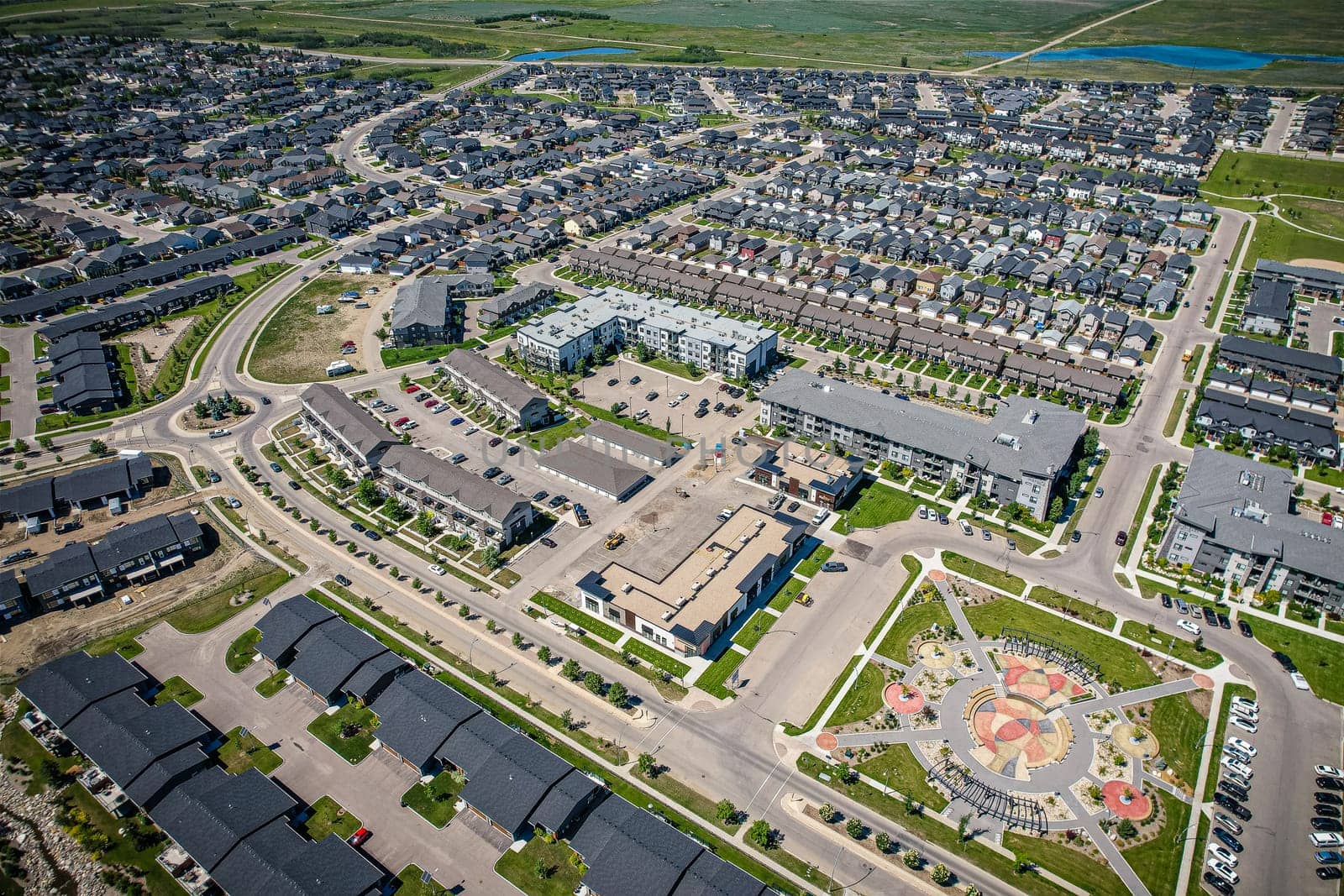 Stunning bird's-eye perspective of the Evergreen neighborhood in Saskatoon, showcasing the unique urban layout and the natural beauty of Saskatchewan's landscapes.