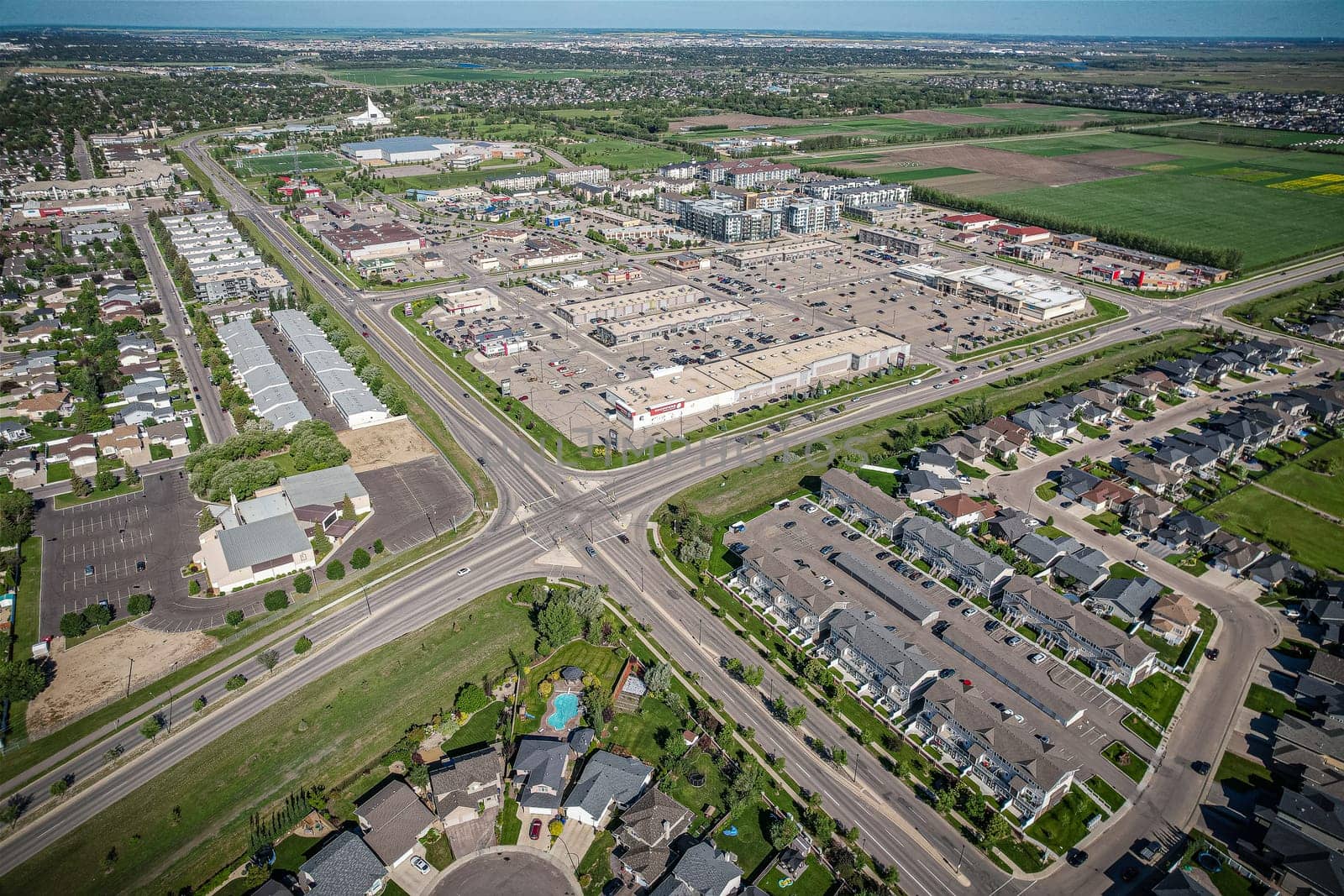 Elevated panorama of Willowgrove, showcasing the neighborhood's modern aesthetics intertwined with pockets of lush green, epitomizing Saskatoon's suburban beauty