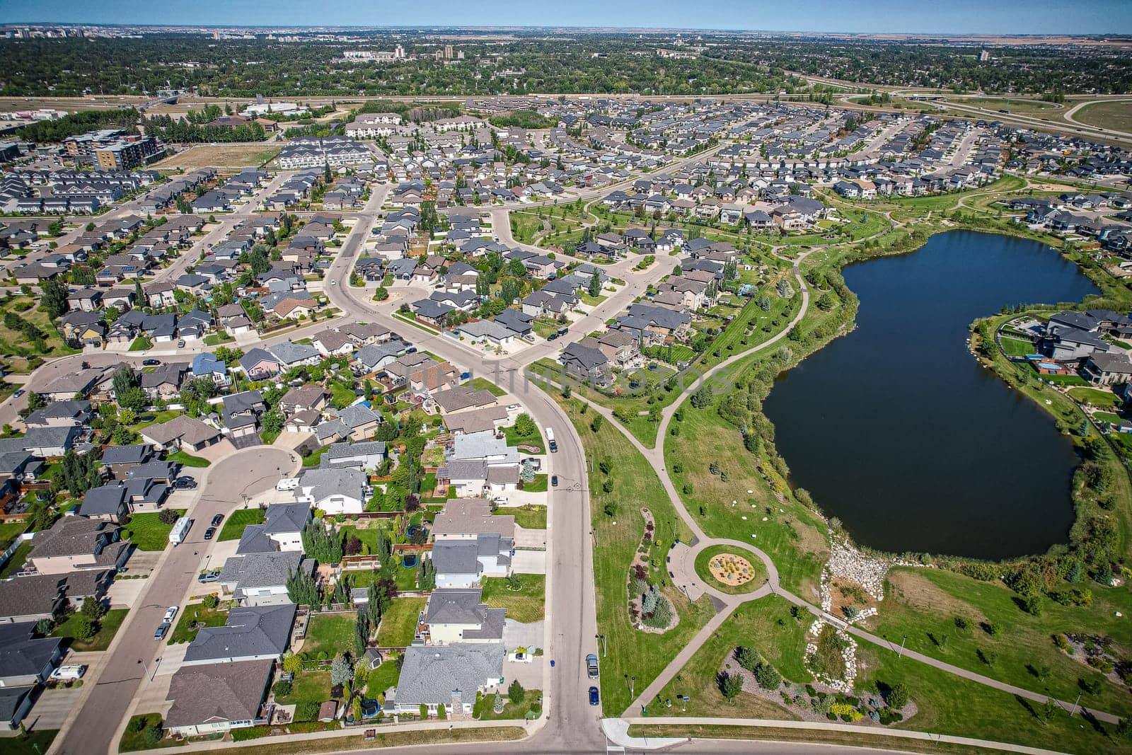 Captivating aerial shot of Stonebridge in Saskatoon, highlighting the harmonious blend of modern architecture and Saskatchewan's verdant surroundings.