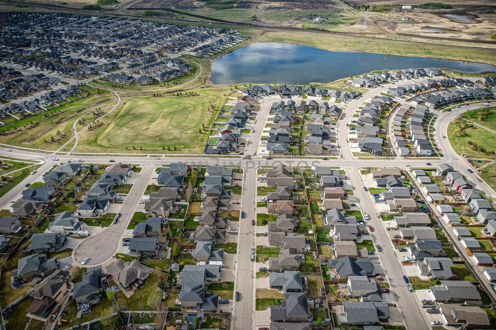 Captivating aerial shot of Stonebridge in Saskatoon, highlighting the harmonious blend of modern architecture and Saskatchewan's verdant surroundings.