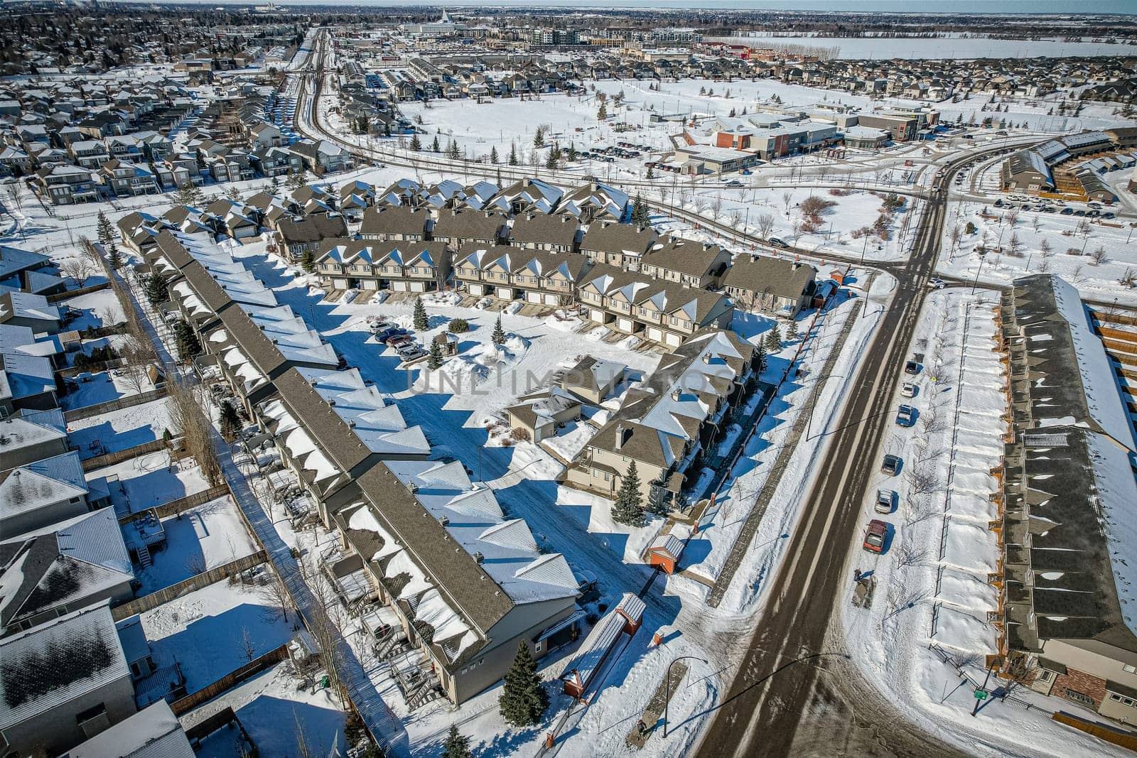 Elevated panorama of Willowgrove, showcasing the neighborhood's modern aesthetics intertwined with pockets of lush green, epitomizing Saskatoon's suburban beauty