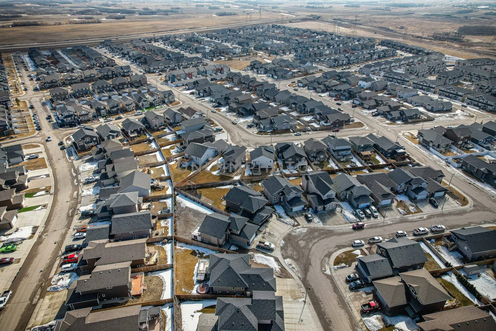 Captivating aerial shot of Stonebridge in Saskatoon, highlighting the harmonious blend of modern architecture and Saskatchewan's verdant surroundings.