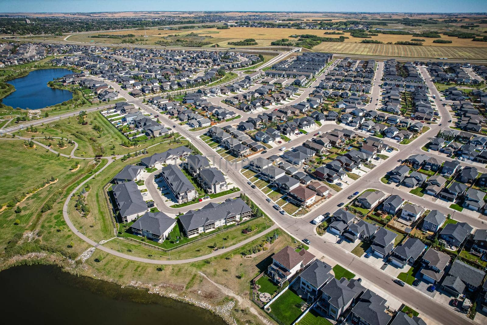 Captivating aerial shot of Stonebridge in Saskatoon, highlighting the harmonious blend of modern architecture and Saskatchewan's verdant surroundings.