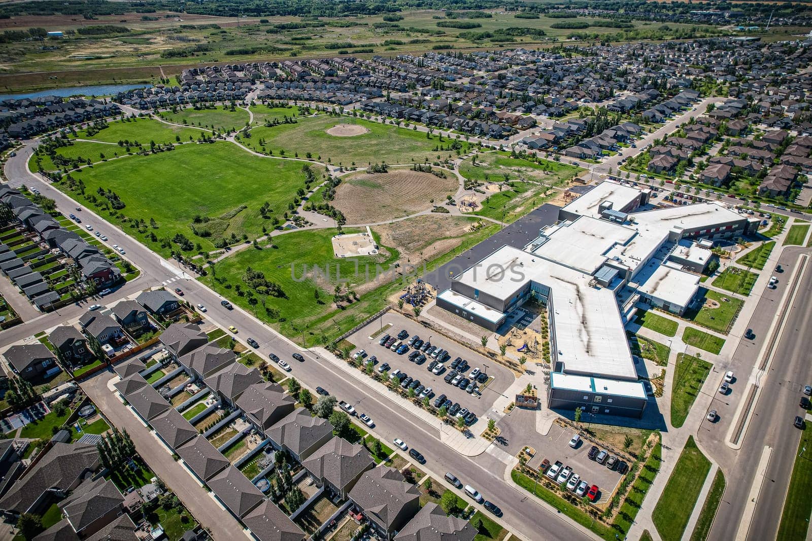Captivating aerial shot of Stonebridge in Saskatoon, highlighting the harmonious blend of modern architecture and Saskatchewan's verdant surroundings.