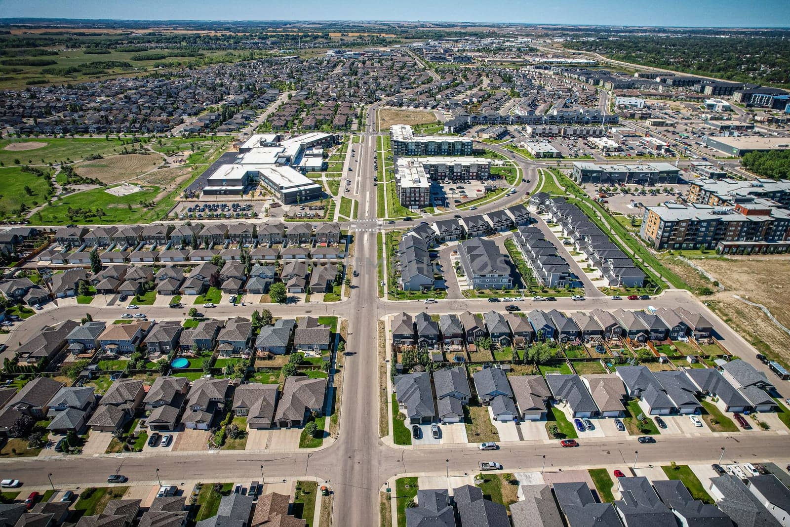 Captivating aerial shot of Stonebridge in Saskatoon, highlighting the harmonious blend of modern architecture and Saskatchewan's verdant surroundings.