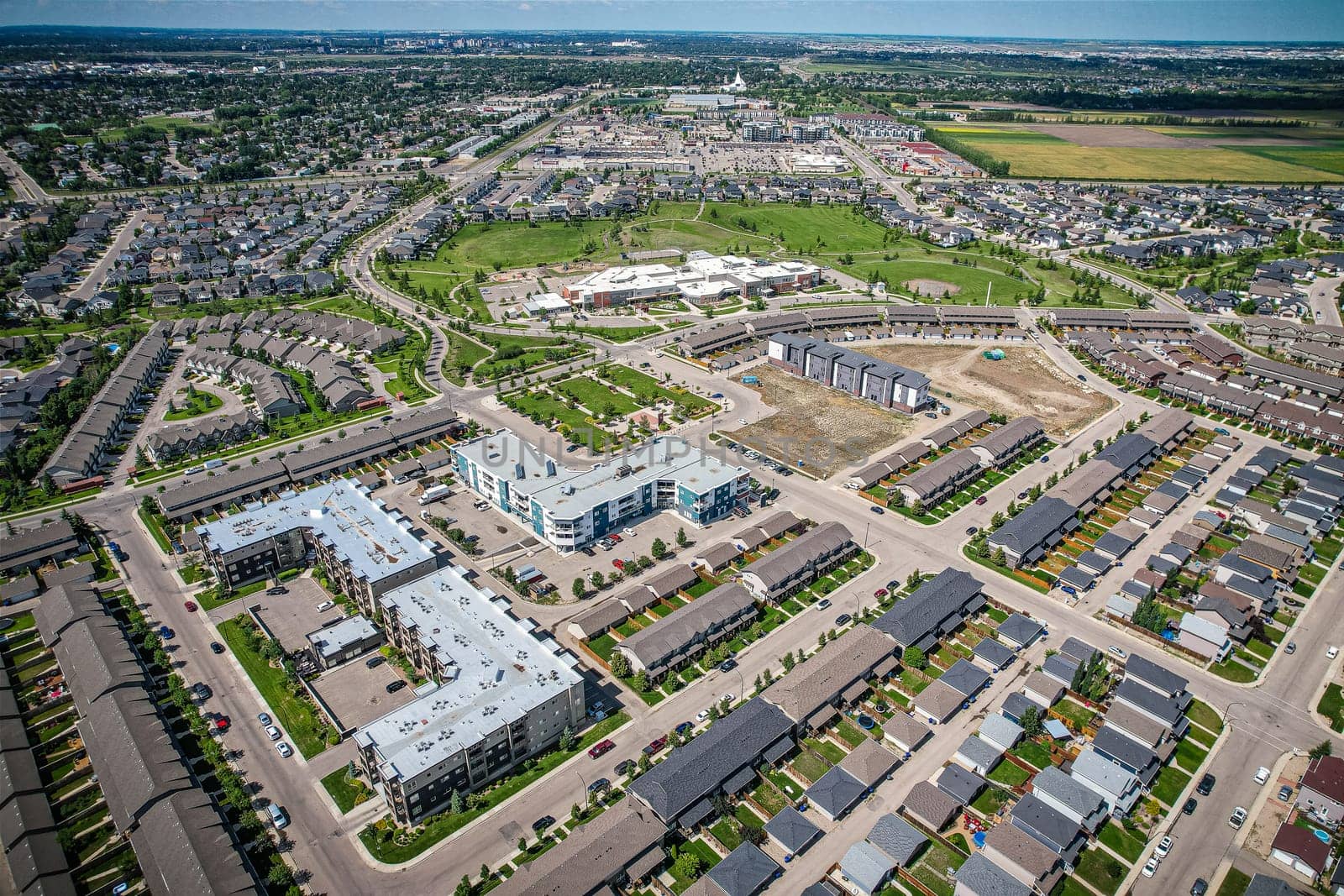 Elevated panorama of Willowgrove, showcasing the neighborhood's modern aesthetics intertwined with pockets of lush green, epitomizing Saskatoon's suburban beauty