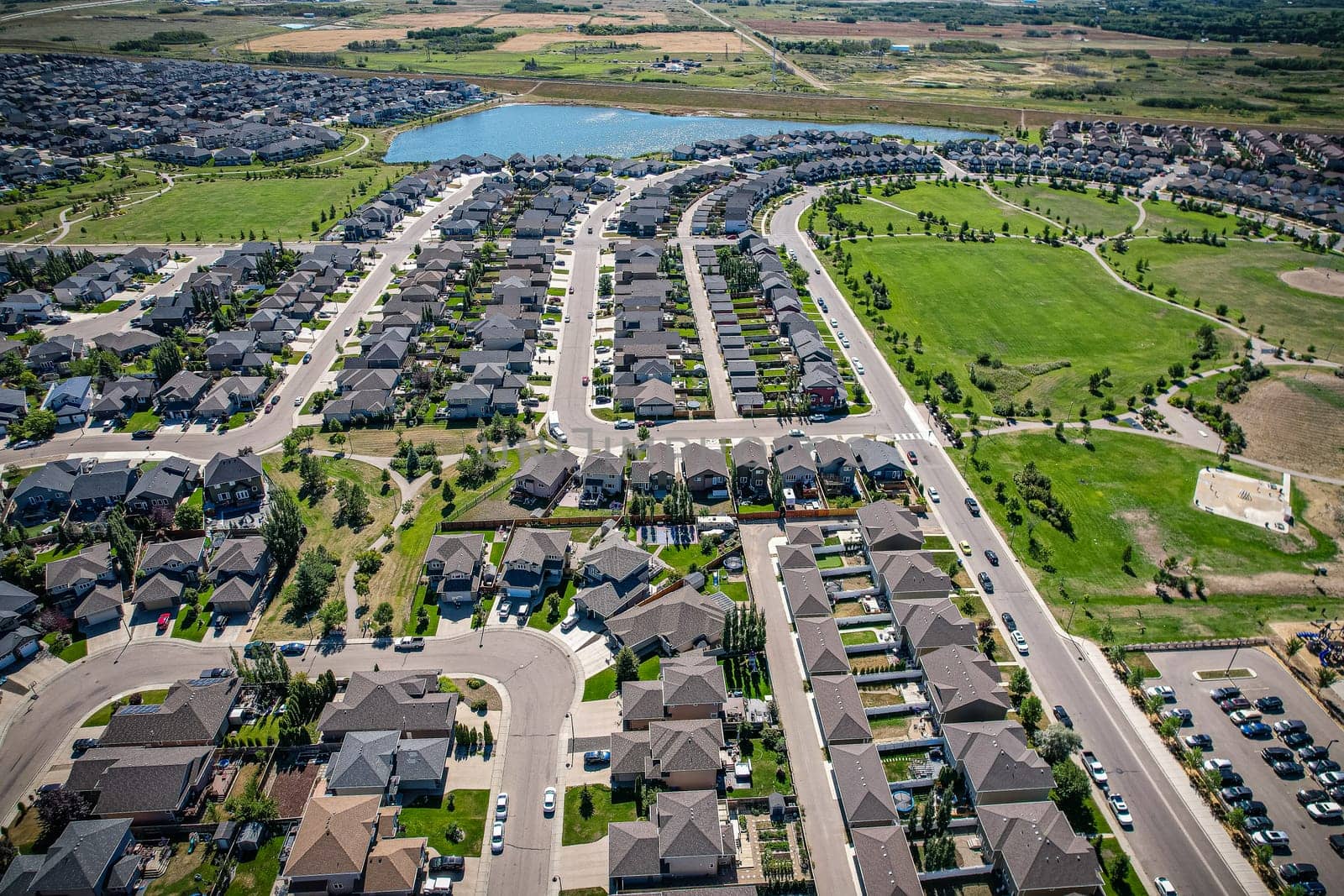 Captivating aerial shot of Stonebridge in Saskatoon, highlighting the harmonious blend of modern architecture and Saskatchewan's verdant surroundings.