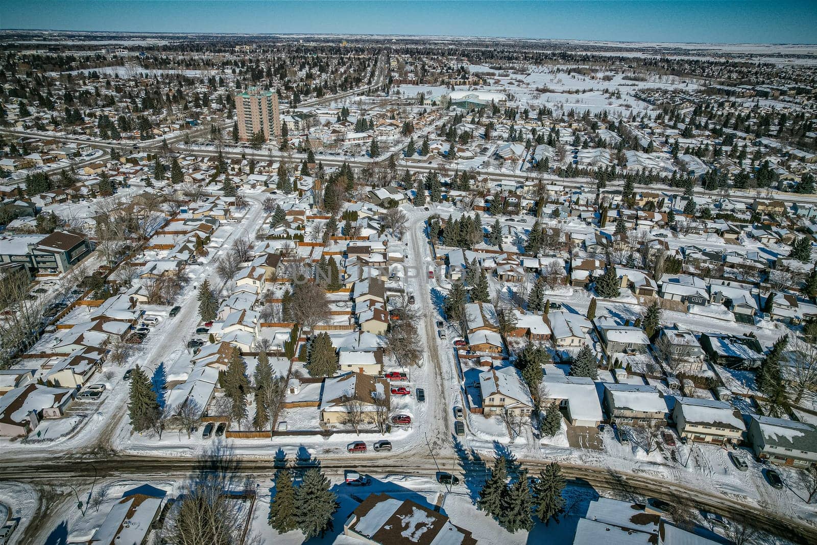 Soaring over Lakeview in Saskatoon, this bird's-eye capture magnifies the neighborhood's tranquil waters, verdant parks, and the serene rhythm of Saskatchewan living