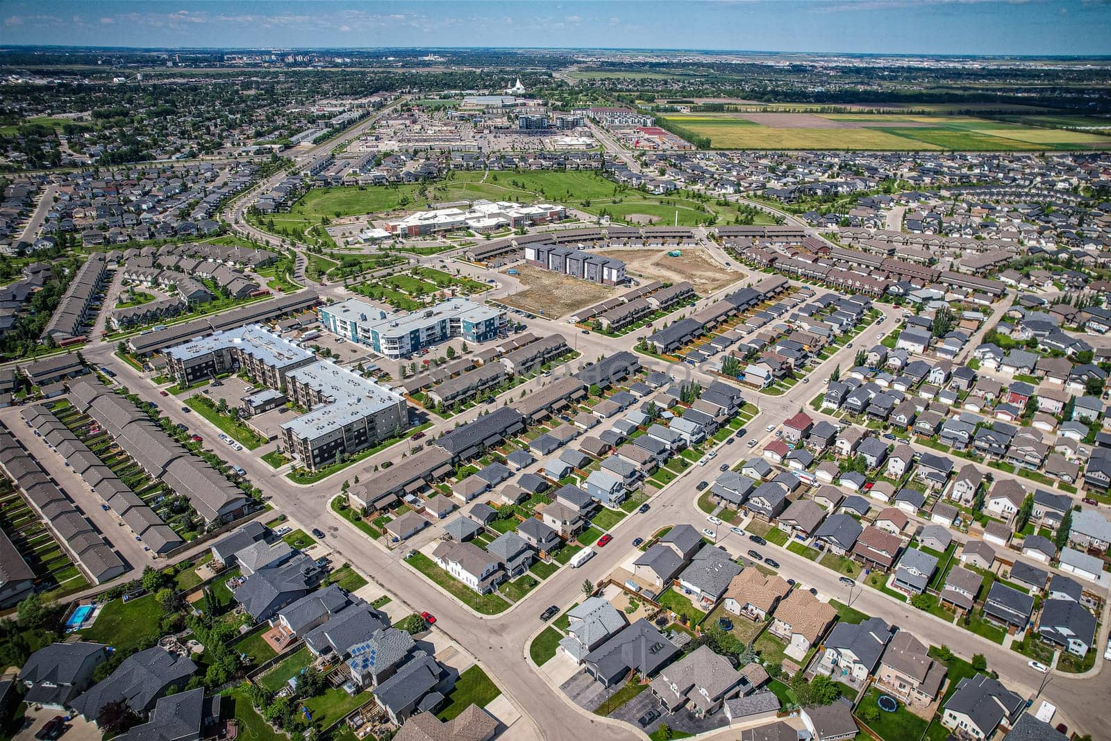 Elevated panorama of Willowgrove, showcasing the neighborhood's modern aesthetics intertwined with pockets of lush green, epitomizing Saskatoon's suburban beauty