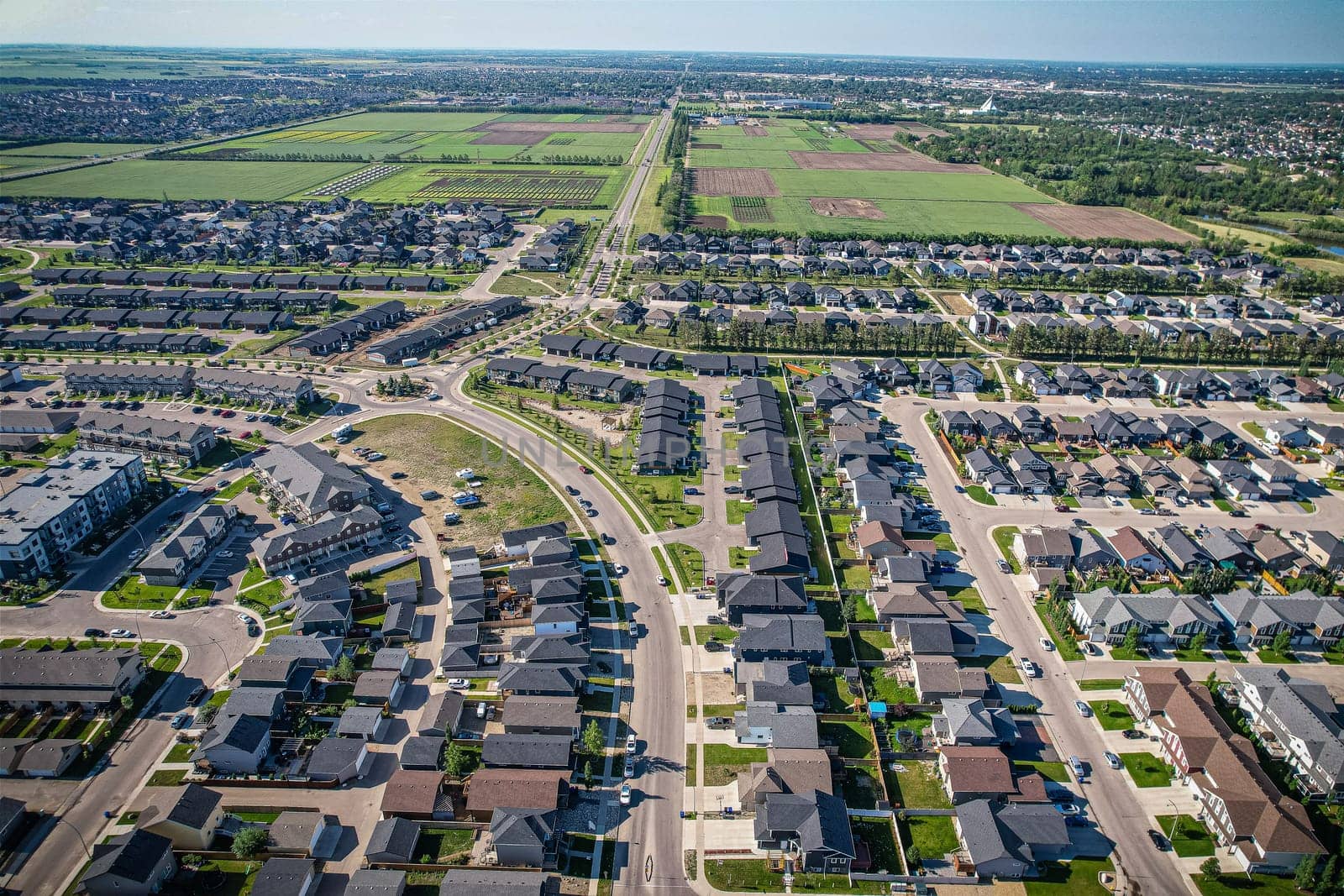 Stunning bird's-eye perspective of the Evergreen neighborhood in Saskatoon, showcasing the unique urban layout and the natural beauty of Saskatchewan's landscapes.