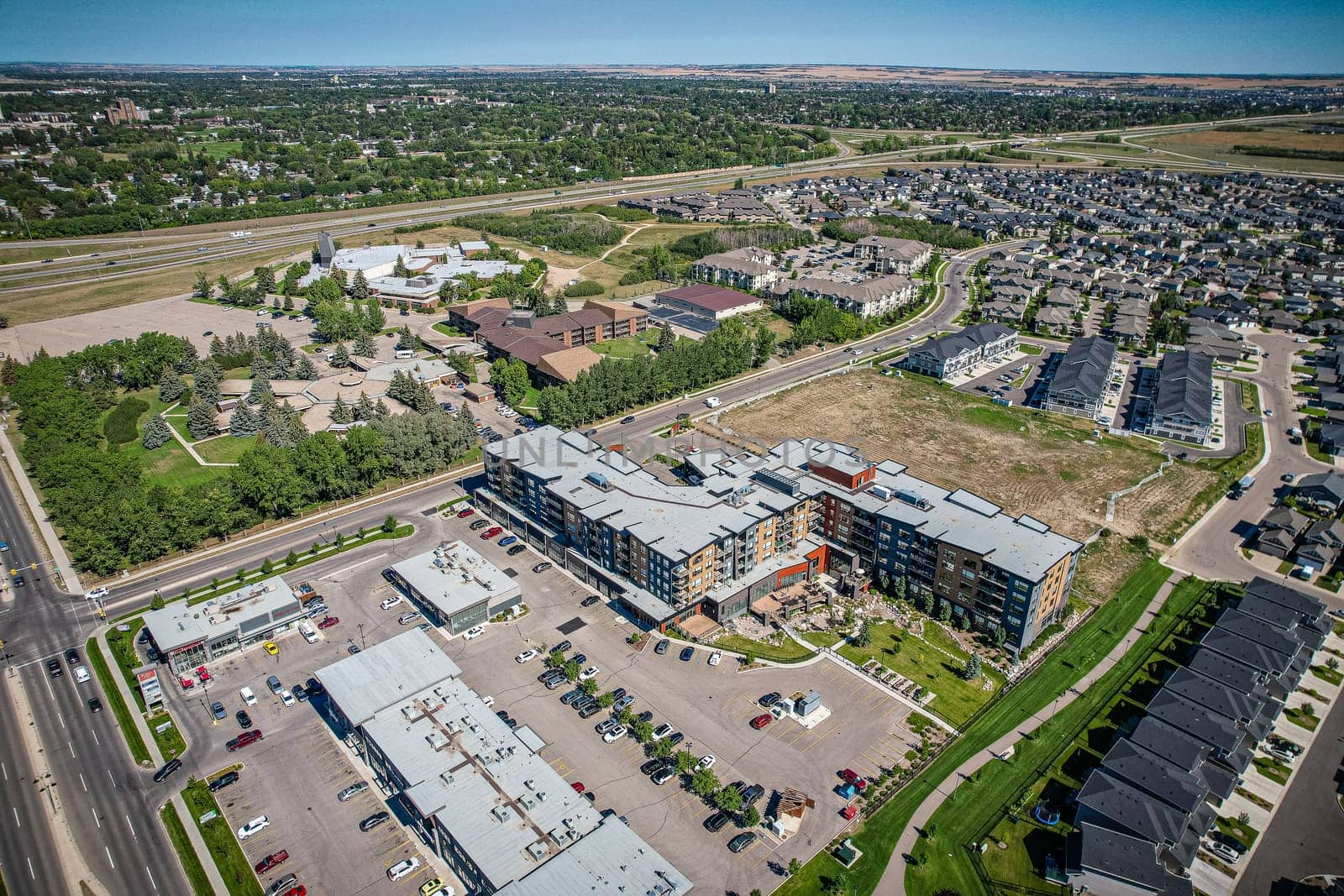 Captivating aerial shot of Stonebridge in Saskatoon, highlighting the harmonious blend of modern architecture and Saskatchewan's verdant surroundings.