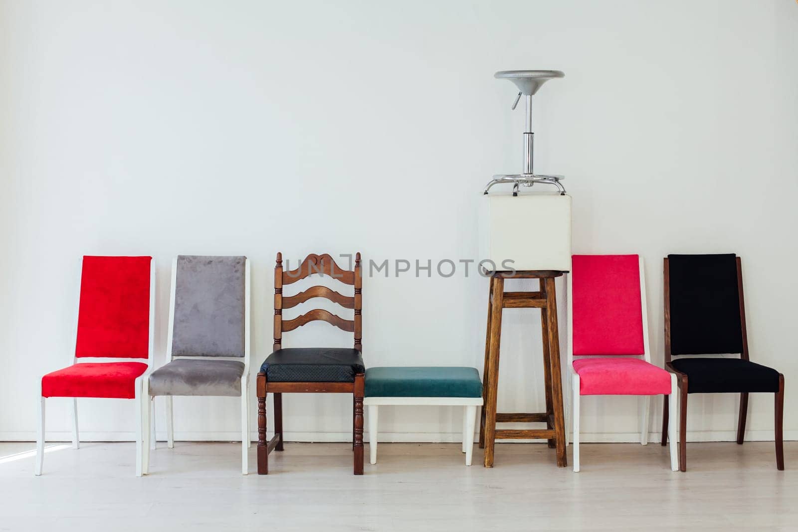 lots of different chairs in the interior of an empty white room by Simakov