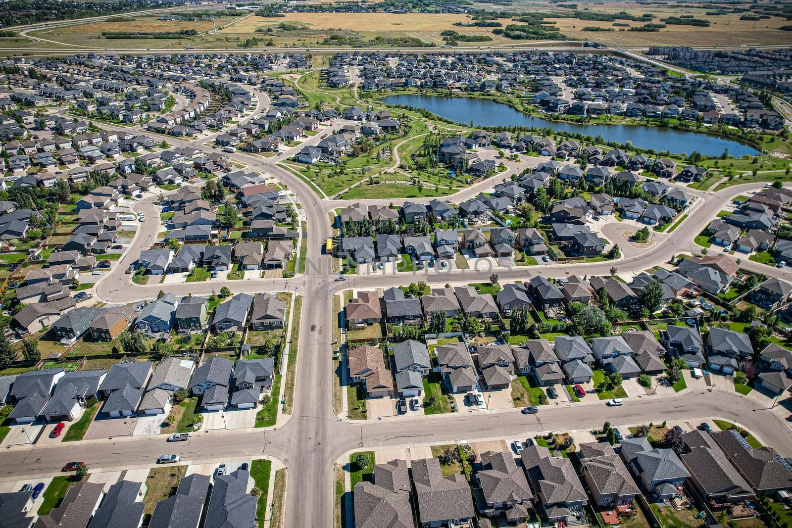 Captivating aerial shot of Stonebridge in Saskatoon, highlighting the harmonious blend of modern architecture and Saskatchewan's verdant surroundings.