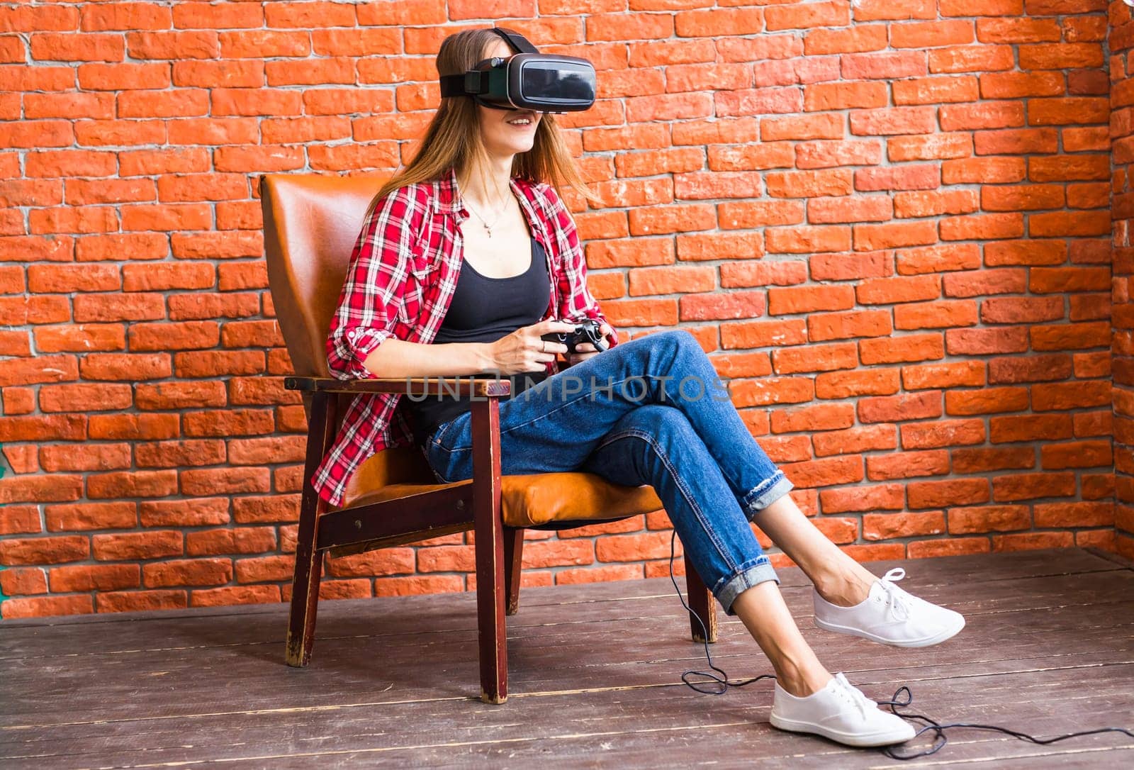 Woman play video game with joystick with VR device.