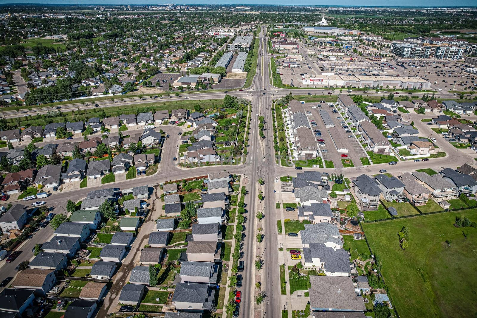 Elevated panorama of Willowgrove, showcasing the neighborhood's modern aesthetics intertwined with pockets of lush green, epitomizing Saskatoon's suburban beauty
