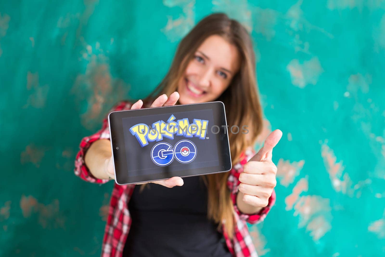 Ufa, Russia. - July 29: Woman show the tablet with Pokemon Go logo, July 29, 2016 in Ufa, Russia by Satura86