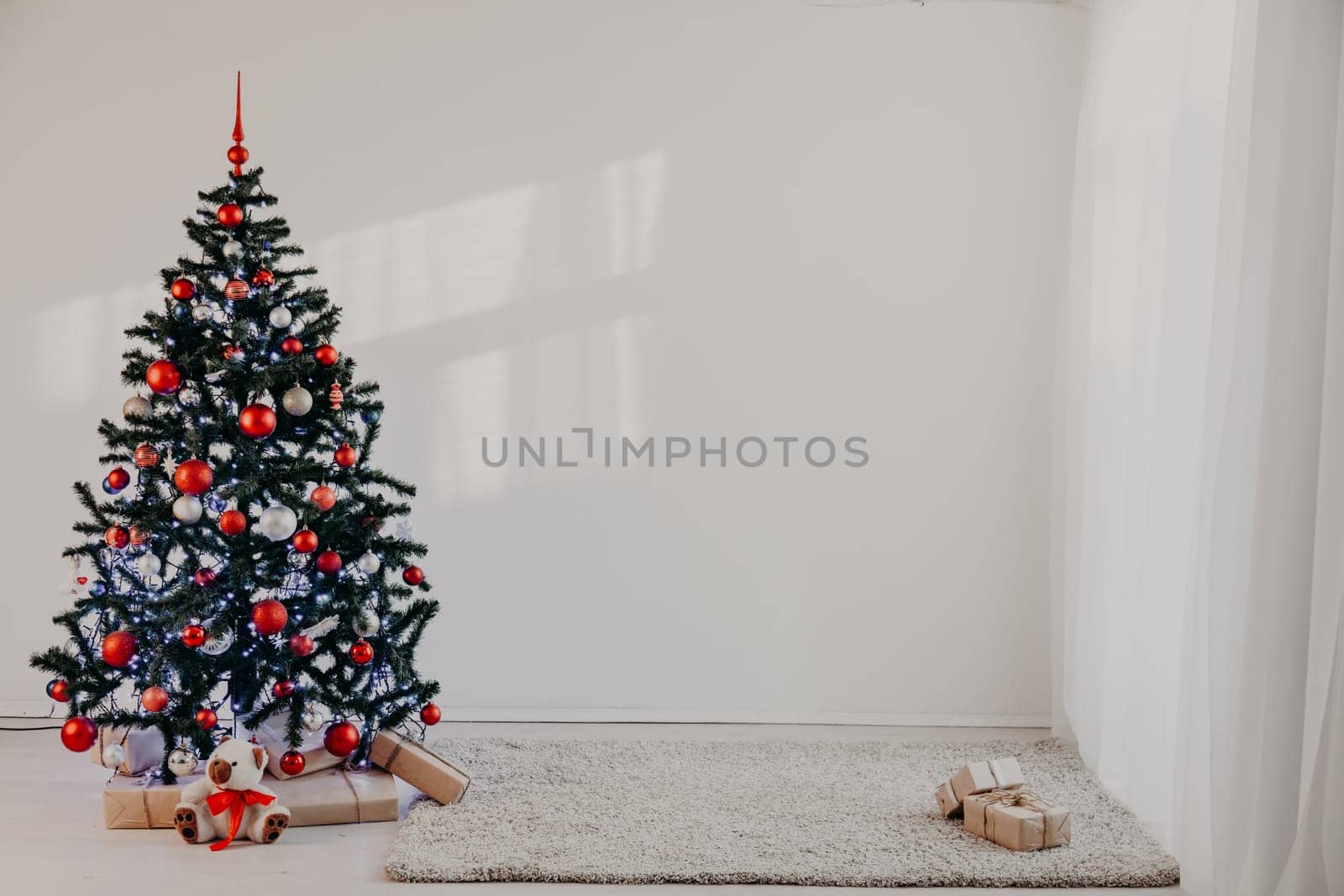 Christmas tree in a white room for Christmas with gifts 2