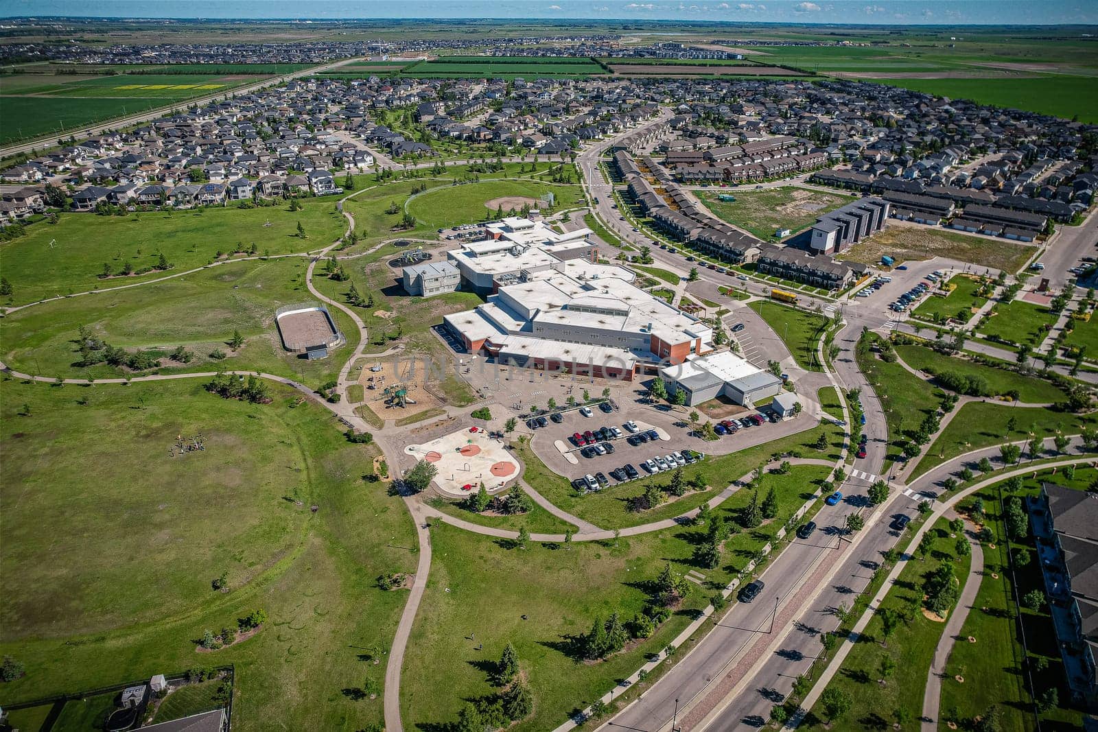 Elevated panorama of Willowgrove, showcasing the neighborhood's modern aesthetics intertwined with pockets of lush green, epitomizing Saskatoon's suburban beauty