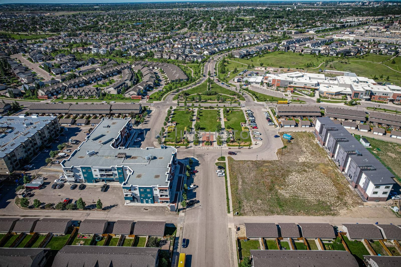 Elevated panorama of Willowgrove, showcasing the neighborhood's modern aesthetics intertwined with pockets of lush green, epitomizing Saskatoon's suburban beauty