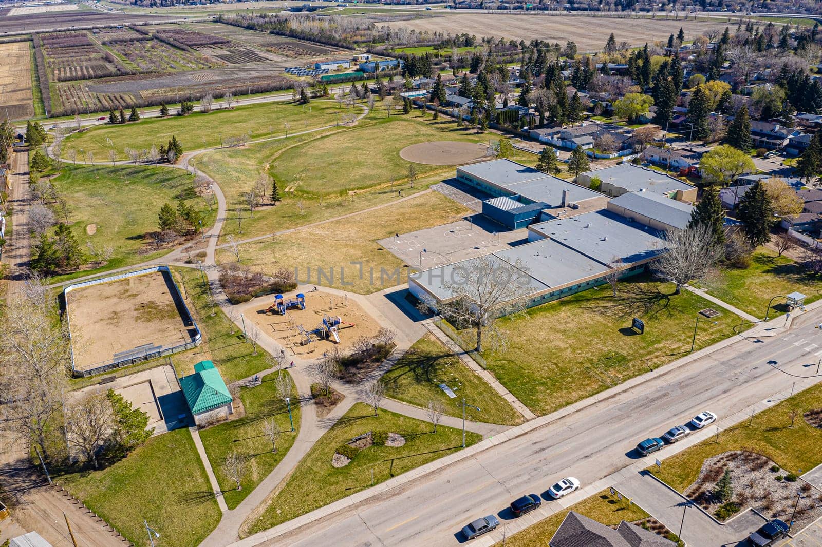 Experience the charm of Greystone Heights in Saskatoon from the sky. This drone image beautifully captures the neighborhood's serene streets, lush parks, and the cohesive community atmosphere.