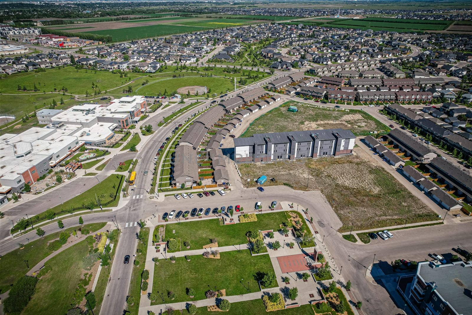 Elevated panorama of Willowgrove, showcasing the neighborhood's modern aesthetics intertwined with pockets of lush green, epitomizing Saskatoon's suburban beauty