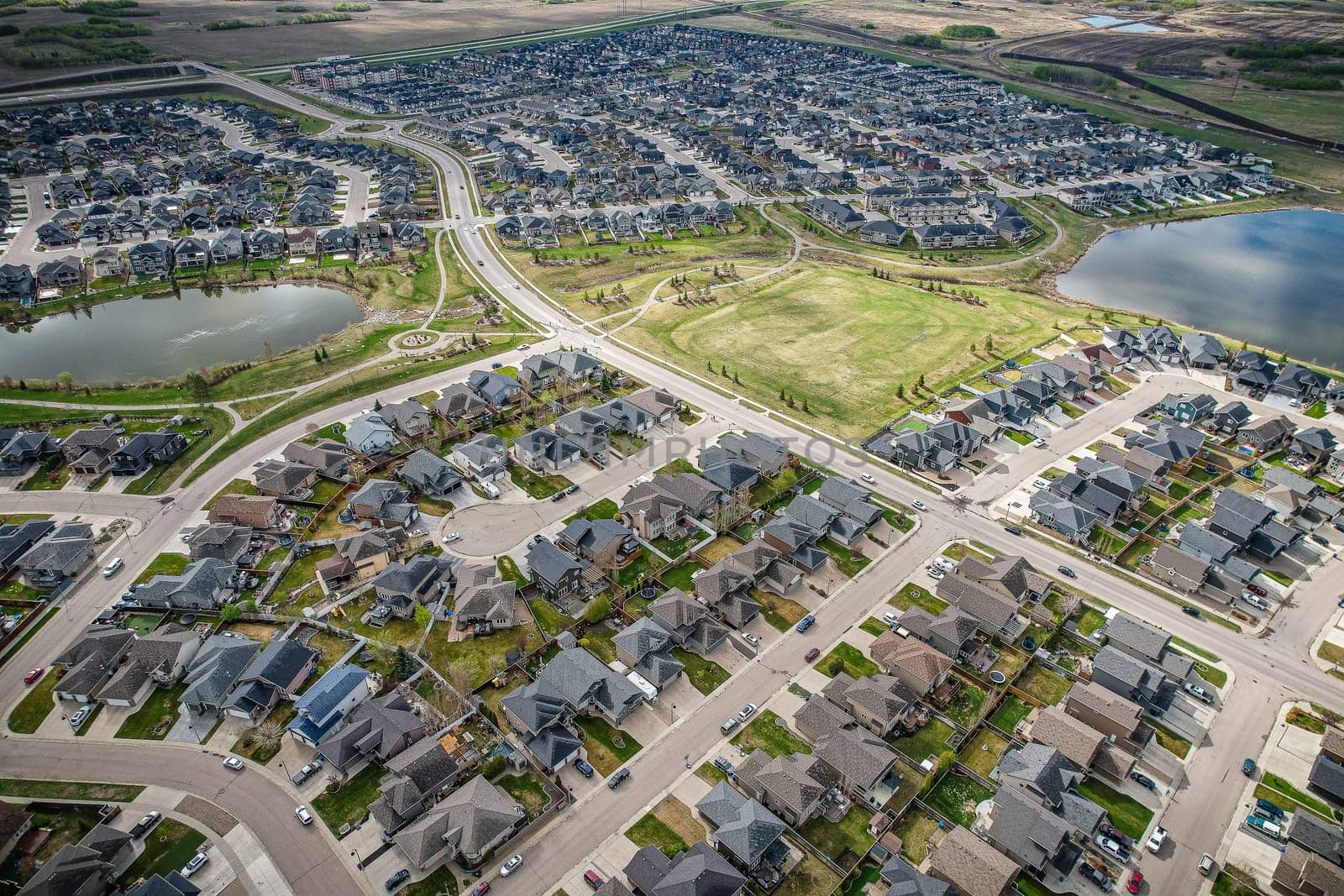 Captivating aerial shot of Stonebridge in Saskatoon, highlighting the harmonious blend of modern architecture and Saskatchewan's verdant surroundings.