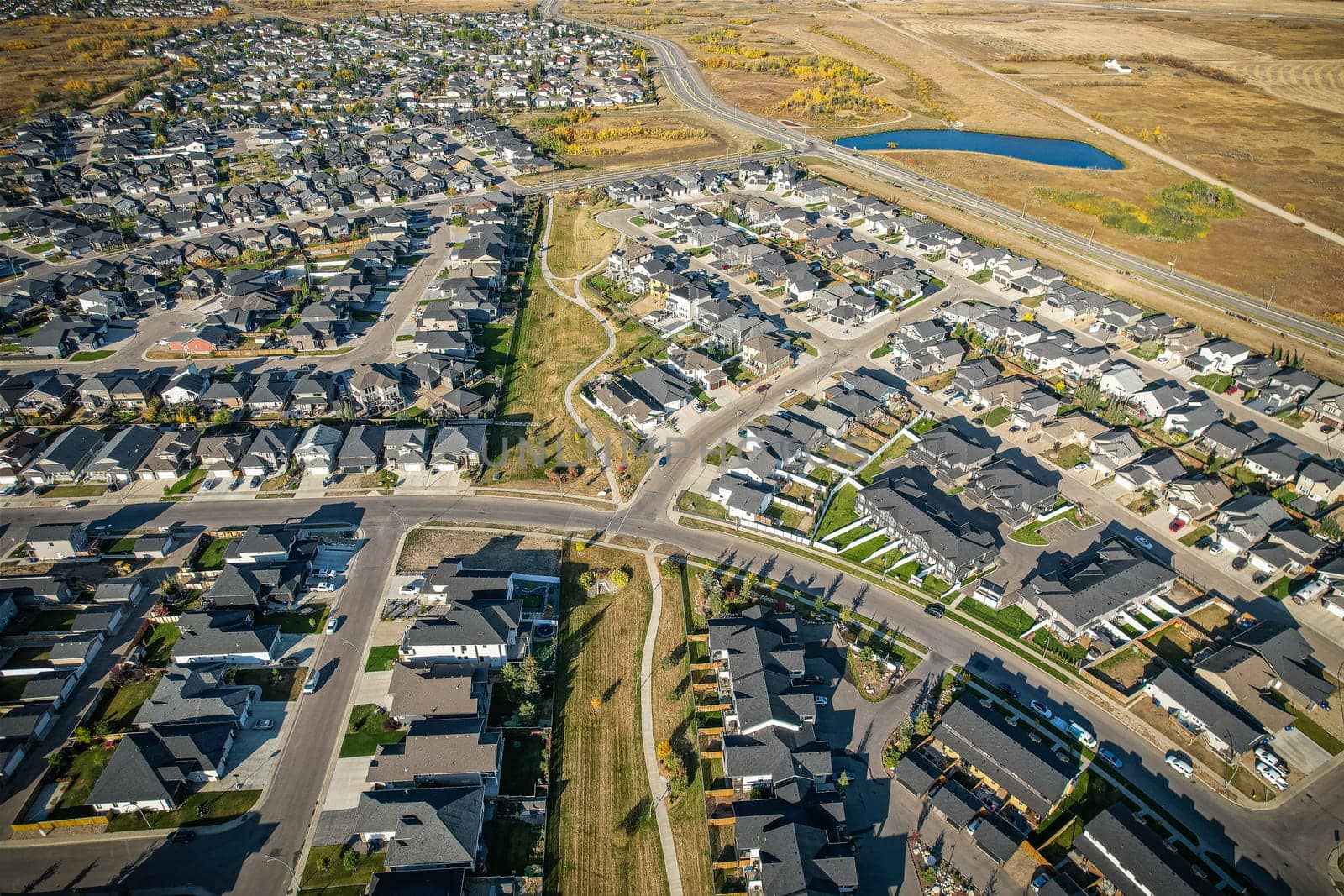 Stunning bird's-eye perspective of the Evergreen neighborhood in Saskatoon, showcasing the unique urban layout and the natural beauty of Saskatchewan's landscapes.