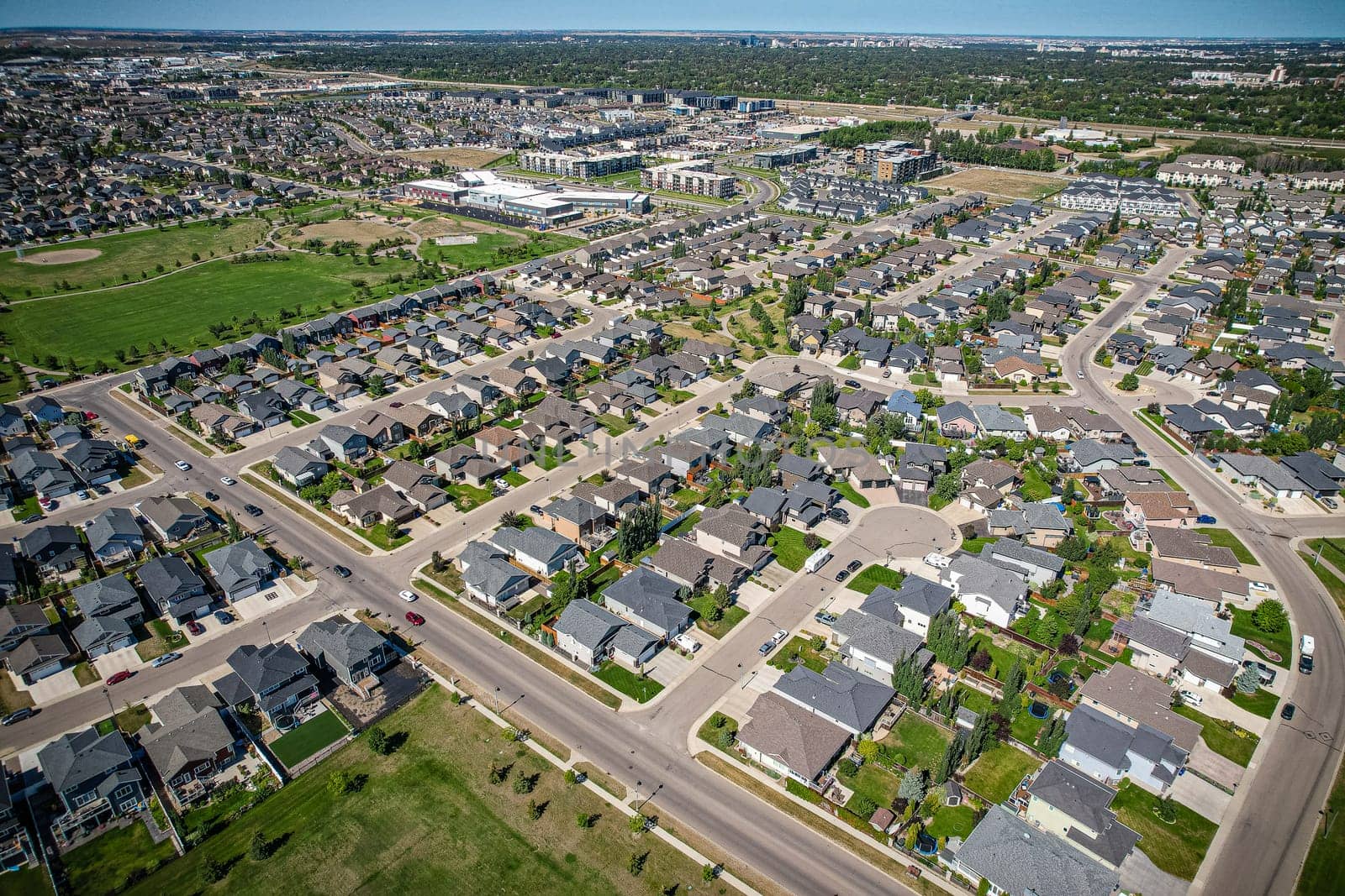 Captivating aerial shot of Stonebridge in Saskatoon, highlighting the harmonious blend of modern architecture and Saskatchewan's verdant surroundings.