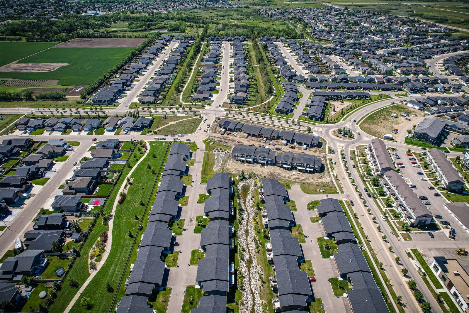 Stunning bird's-eye perspective of the Evergreen neighborhood in Saskatoon, showcasing the unique urban layout and the natural beauty of Saskatchewan's landscapes.