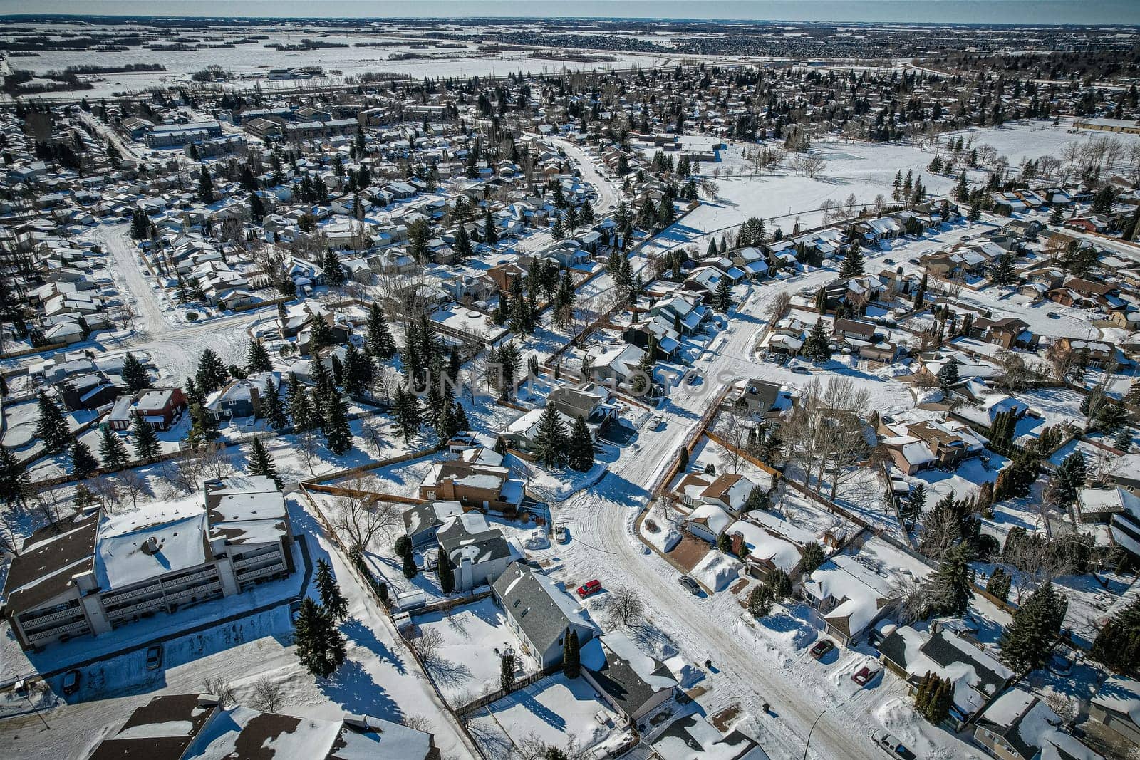 Soaring over Lakeview in Saskatoon, this bird's-eye capture magnifies the neighborhood's tranquil waters, verdant parks, and the serene rhythm of Saskatchewan living