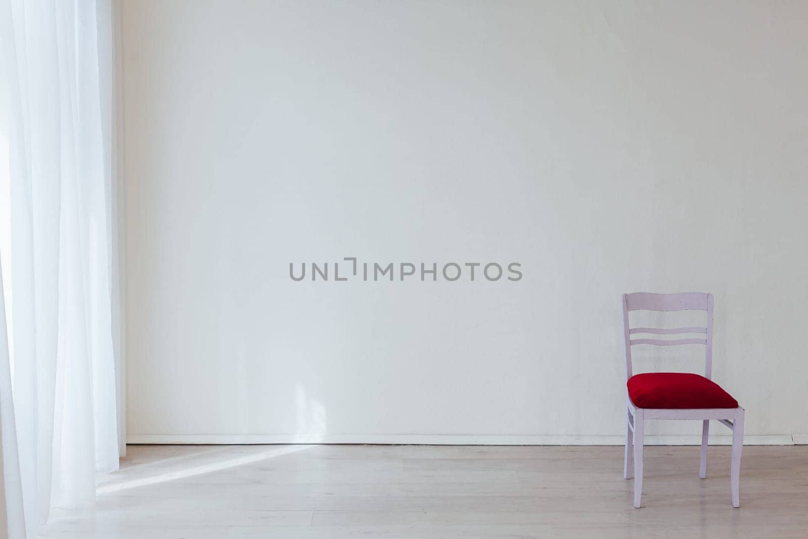 one chair in the interior of a white empty room by Simakov